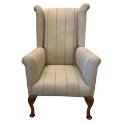 Circa 1900 English Wingback Armchair with Walnut Legs in a Neutral Linen Fabric