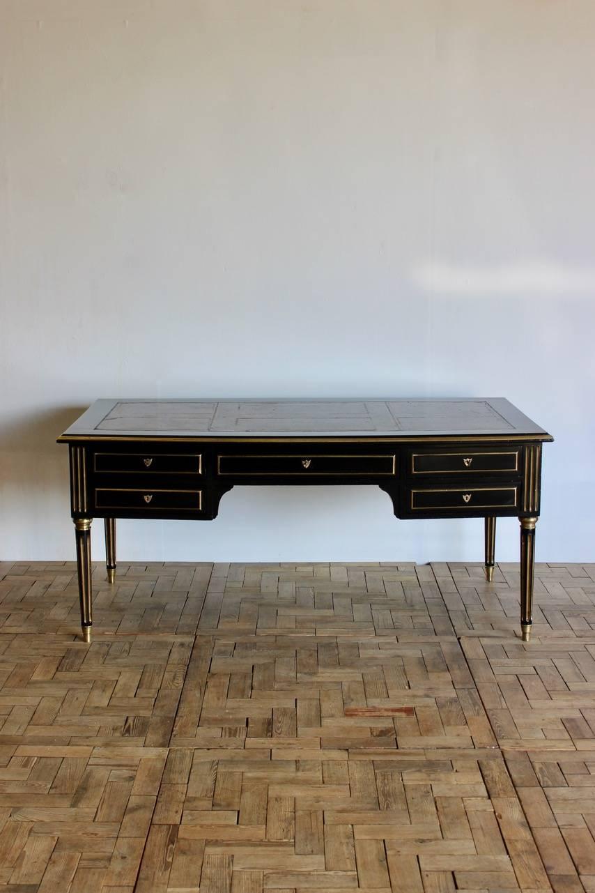 A good quality and of elegant proportions, circa 1900 French double sided ebonized desk in the Louis XVI taste with five drawers, original brass mounts and leather top. This elegant desk would work well in most settings.

Measure: 61cm high (leg