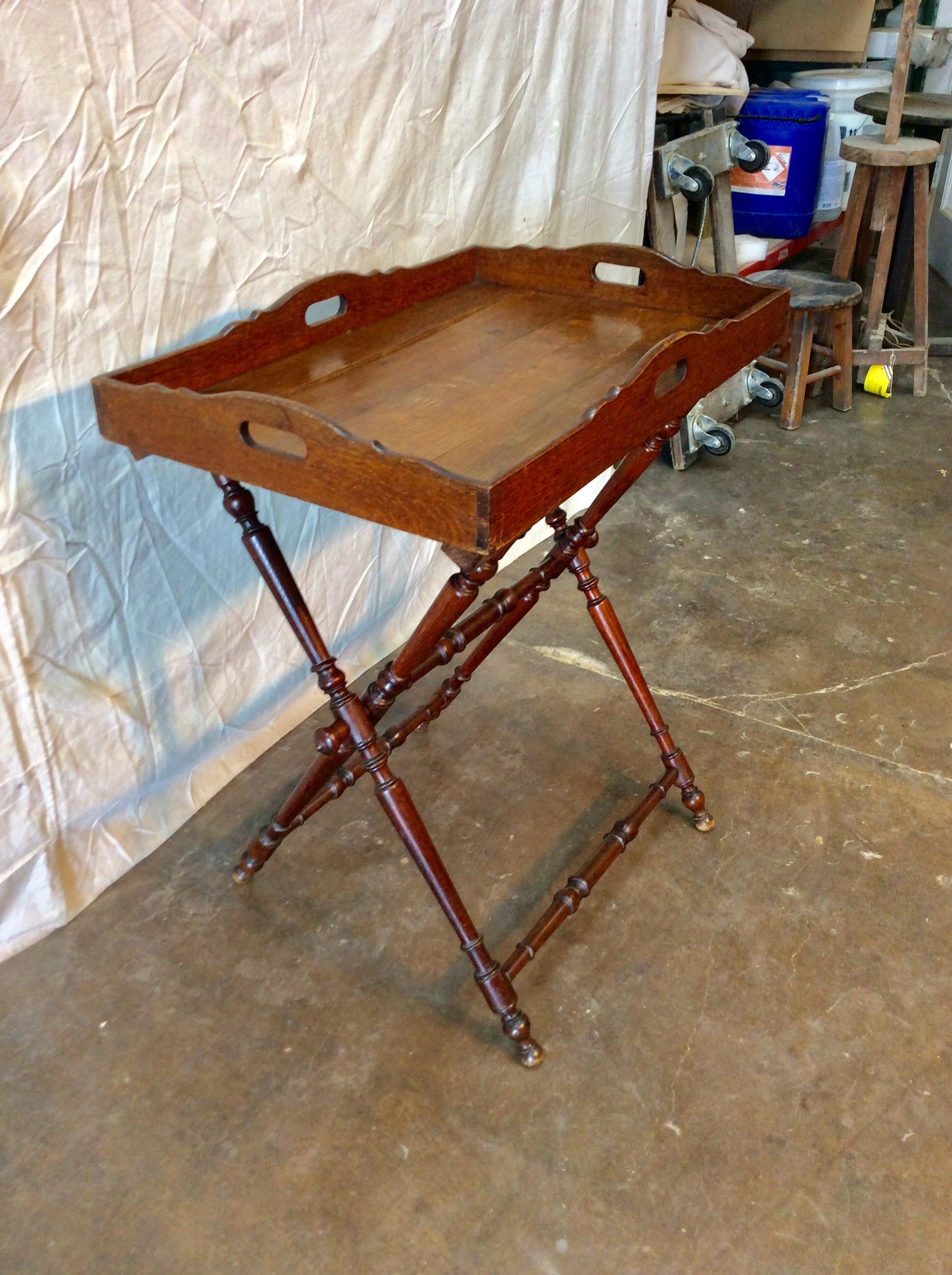 Found in the South of France, this circa 1900 French Butler's tray with foldable stand is walnut and set on turned trestle legs. The removable tray measures is 27