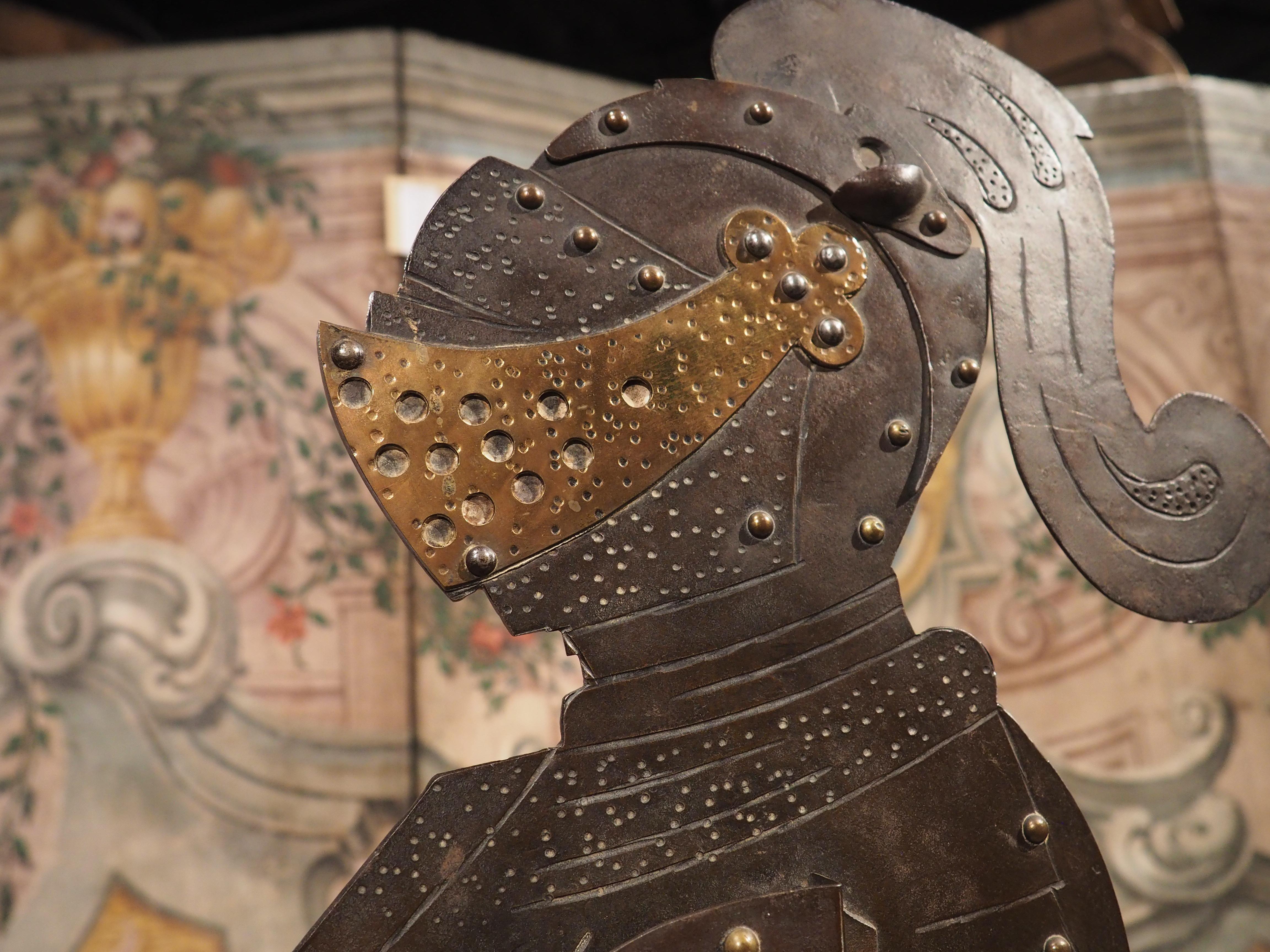 Truly a one-of-a-kind item, this four foot tall cigar cutter with candle holder is in the shape of an armored knight holding a lance. Our knight was crafted in iron and adorned with brass nailheads along his full set of armor, including a gold
