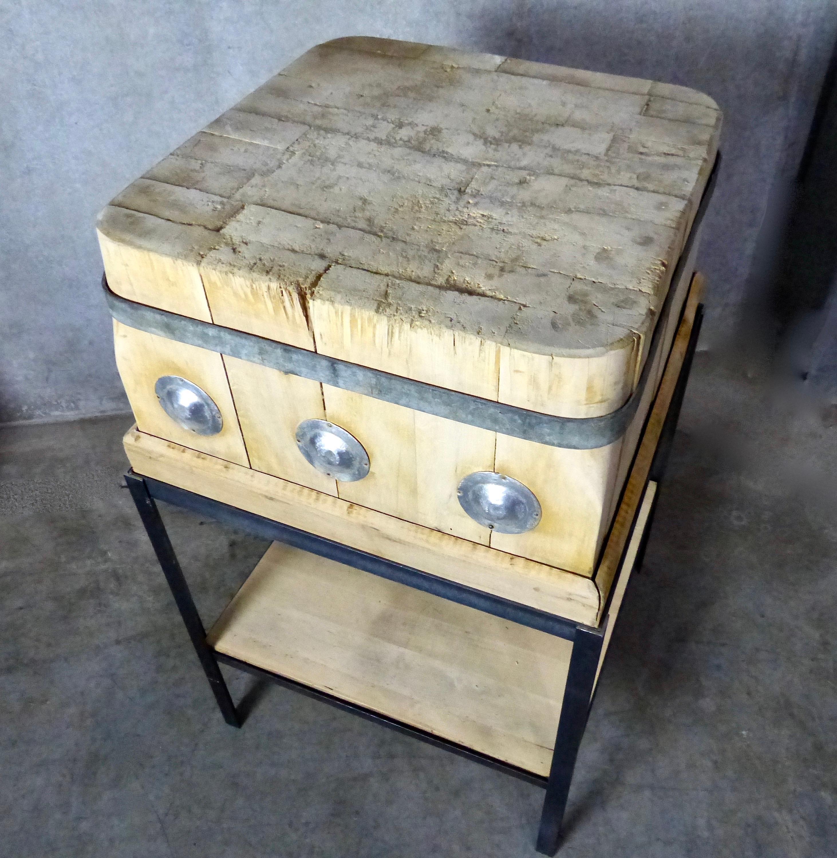 A wonderfully aged butcher block, circa 1900 and made from maple wood, that has been mounted on a bespoke steel base. Original circular metal medallions and metal strapping. Includes a lower shelf made from reclaimed wood. Great accent piece for a