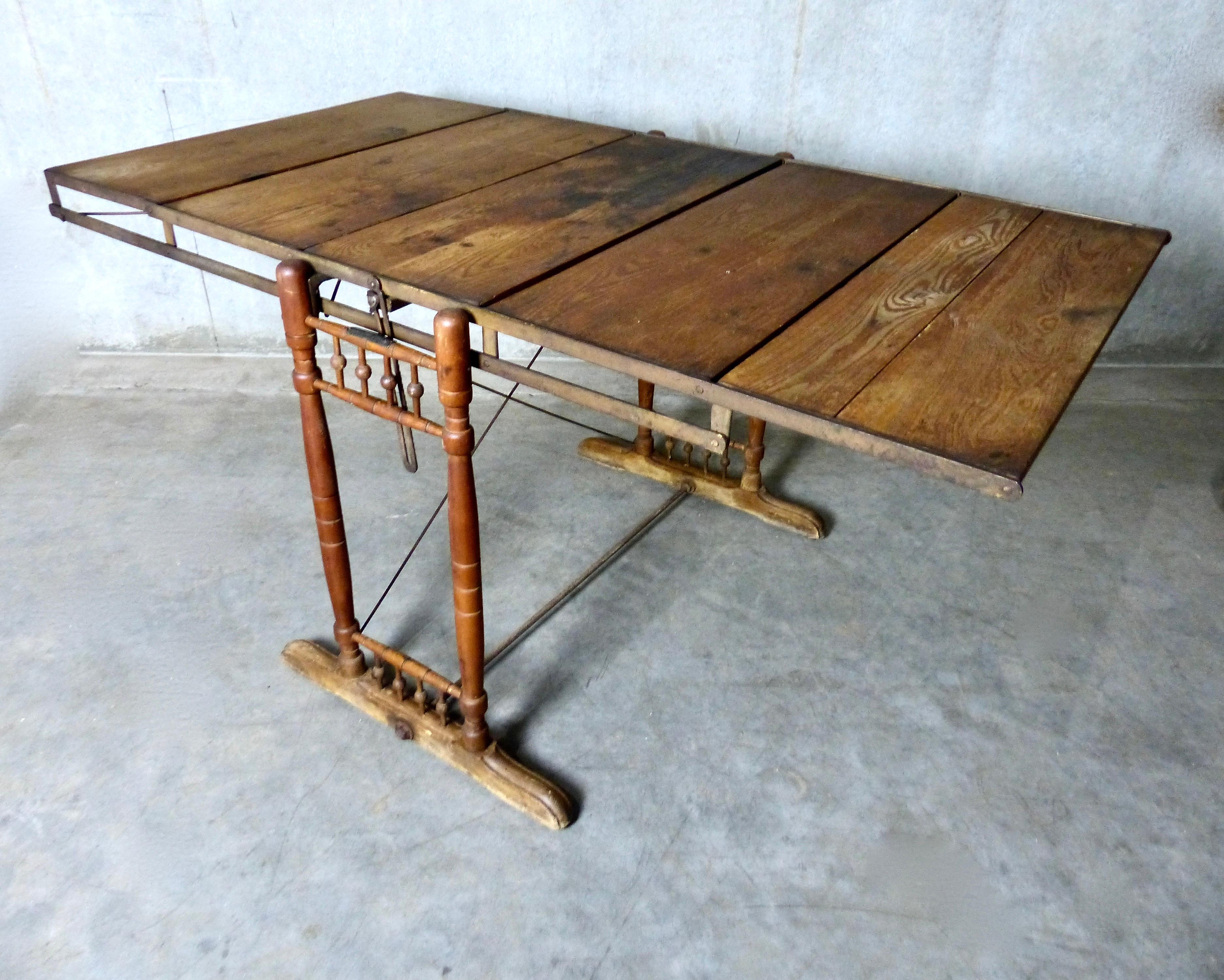 A multi-position shelving unit that collapses to become a merchandising table (or vice versa). The unique unit was patented in 1896 by The Combination Table Co. This example, from circa 1900, is made from solid wood with metal extension