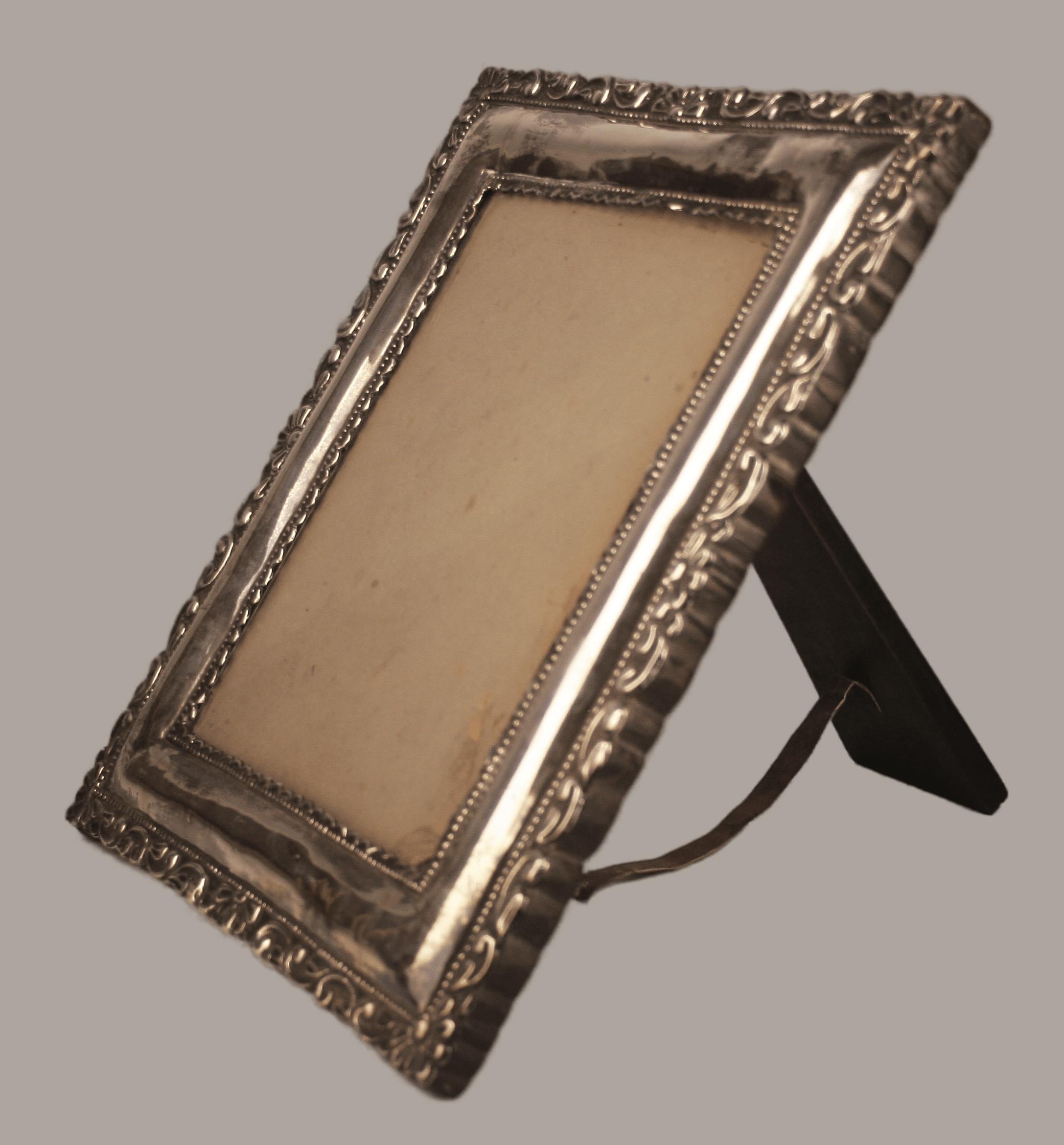 Circa 1900 Neoclassical wooden frame with repoussé silvered metal front plate

By: unknown
Material: glass, silver, wood, metal, leather
Technique: repoussé, polished, metalwork, silvered
Dimensions: 1.5 in x 11.5 in x 13.5 in
Date: circa