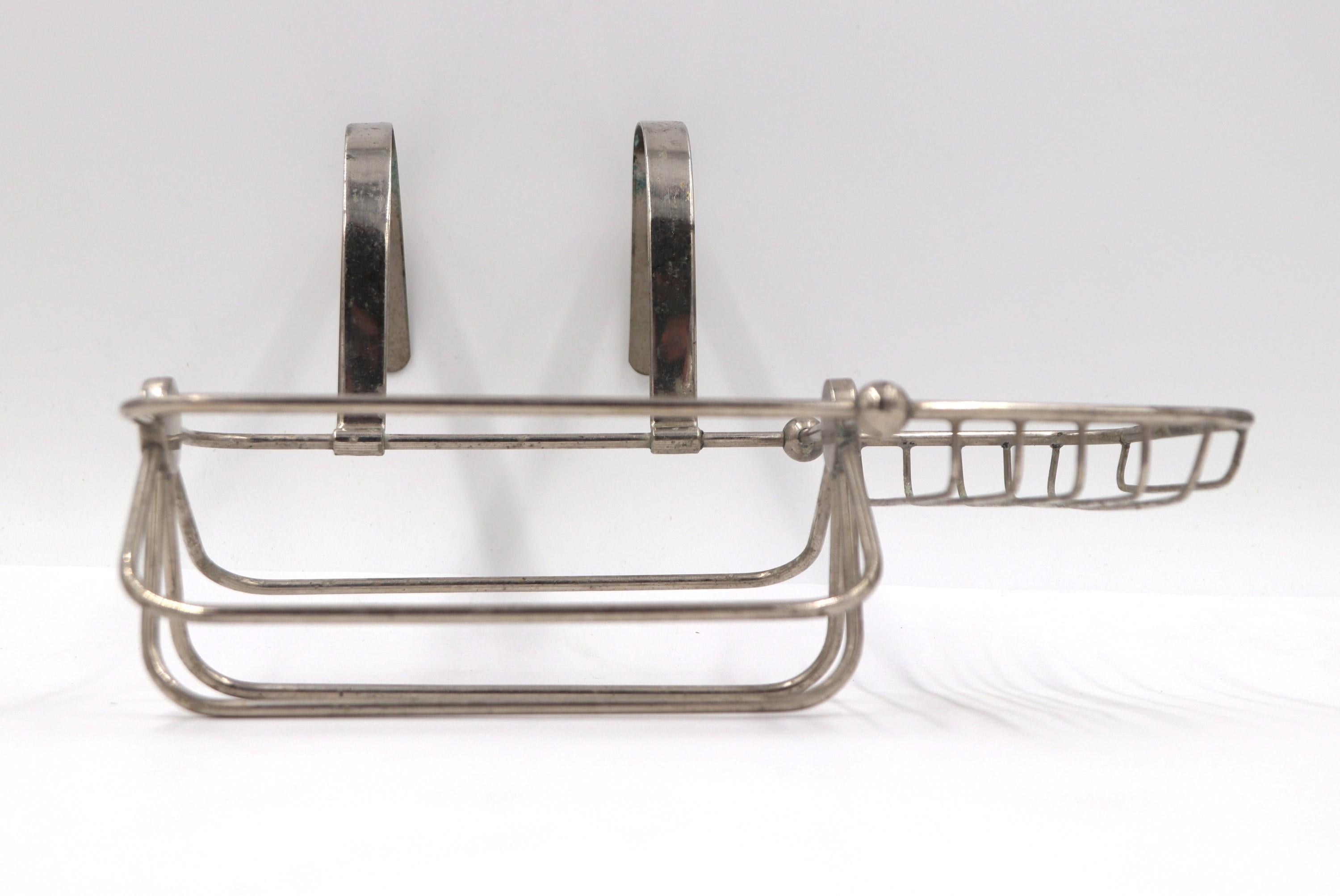 This antique nickel plated over brass soap holder mounts to the side of the tub and features two sections, one for sponges and the other for soap.  There is some overall wear from age and use. This can be seen at our 333 West 52nd St location in the