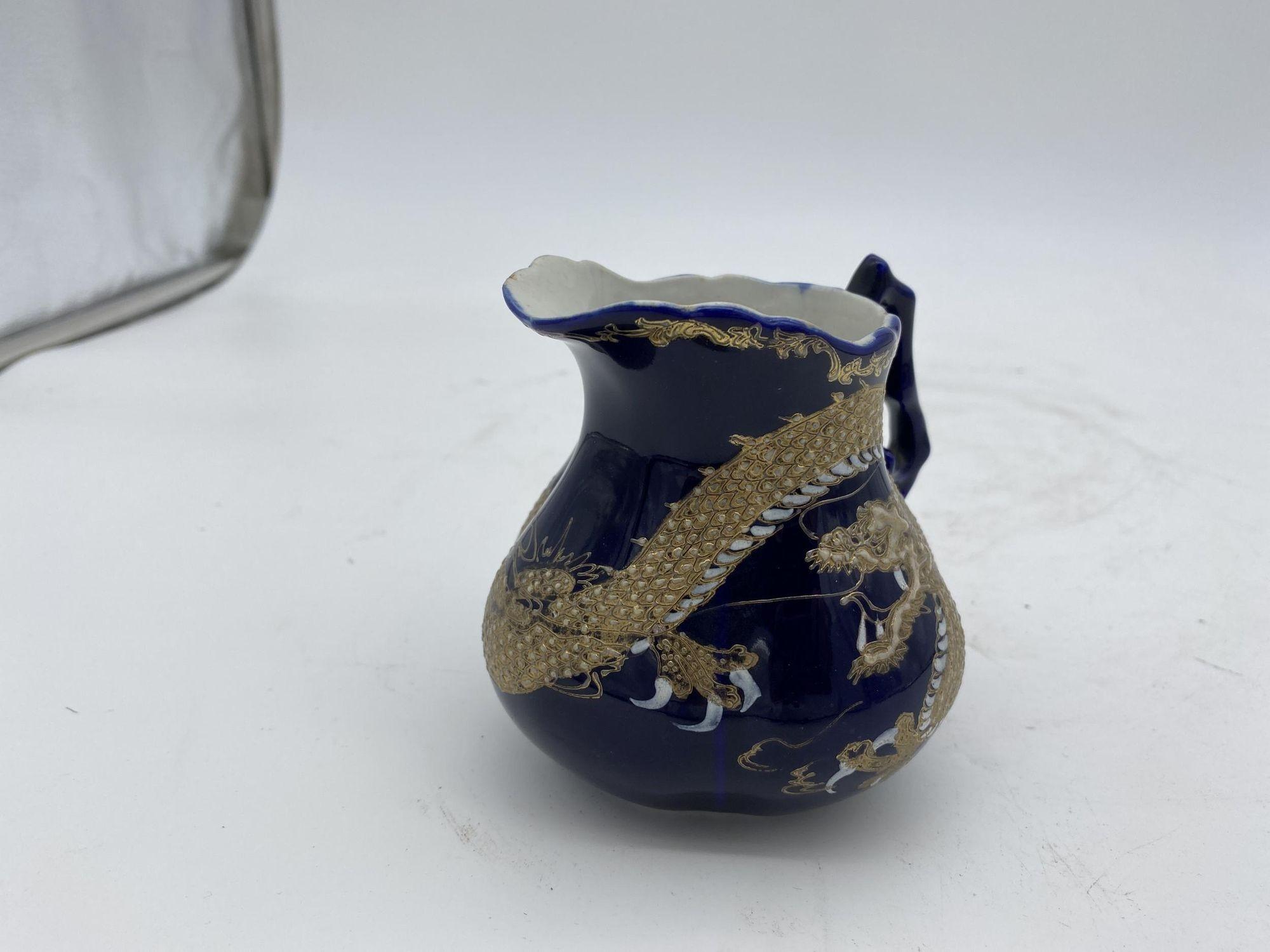 Pre-War cobalt blue creamer vase with silver leaf Chinese dragon.

circa 1900.