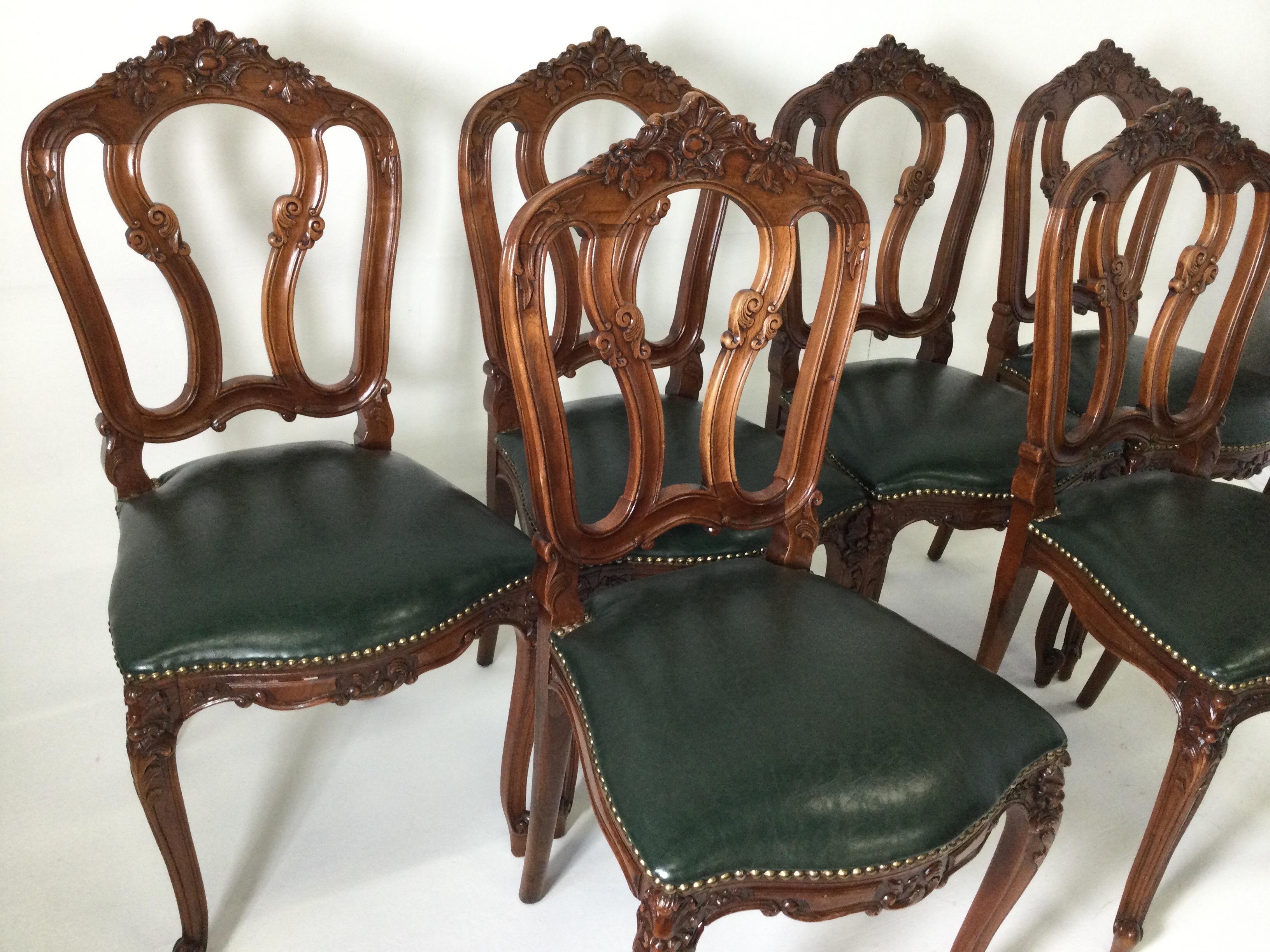 Set of six carved French style walnut chairs with green leather seats, circa 1900
Traditional shape and form with beautiful hand carving. The rich dark green leather seats are attached with antique brass nailhead trim. Very clean