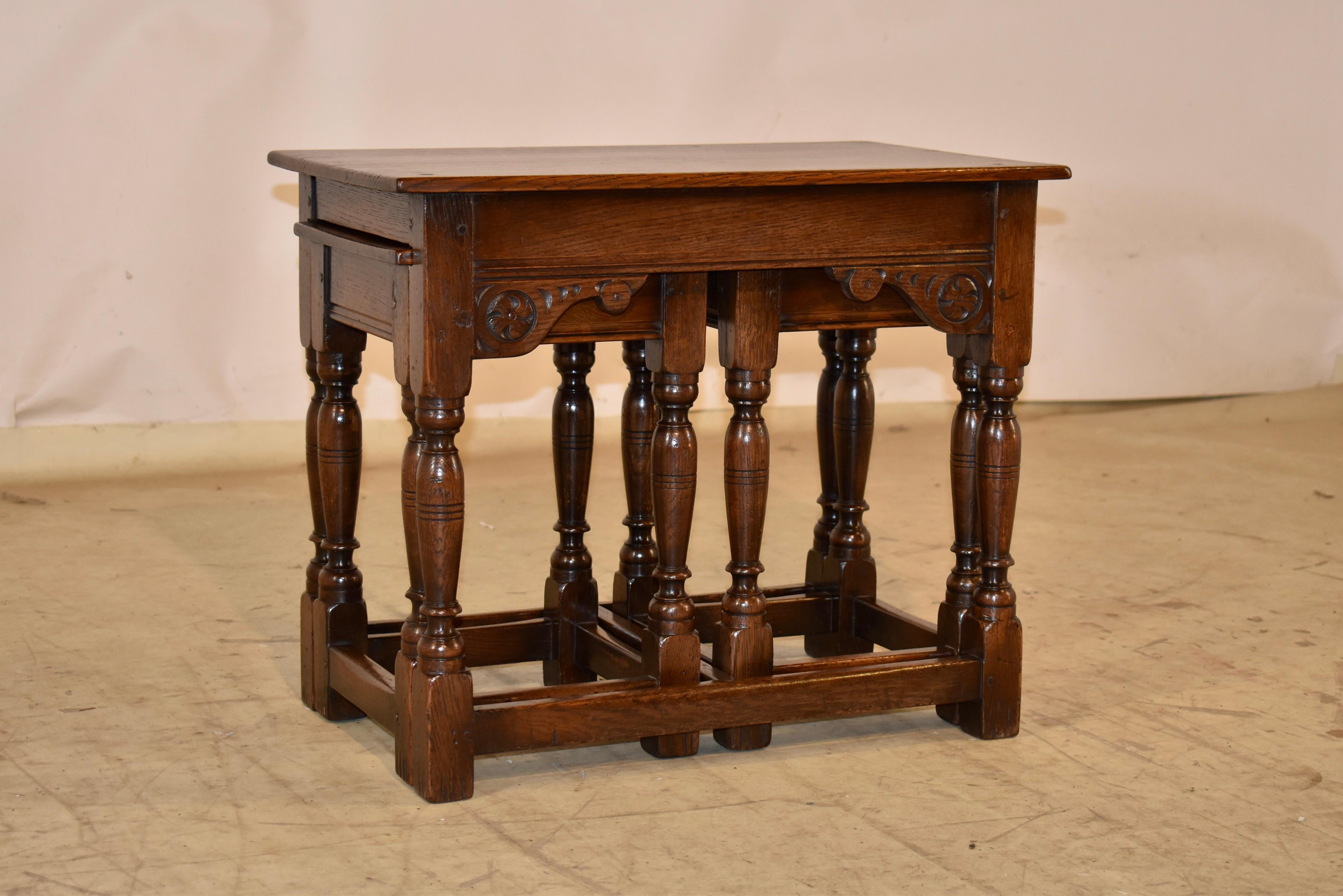 English oak set of three nesting tables, circa 1900.  This style of table is so useful anywhere in the home or office!  The tables are made from oak and have pegged construction.  

The tops of the tables are simple, and follow down to simple aprons