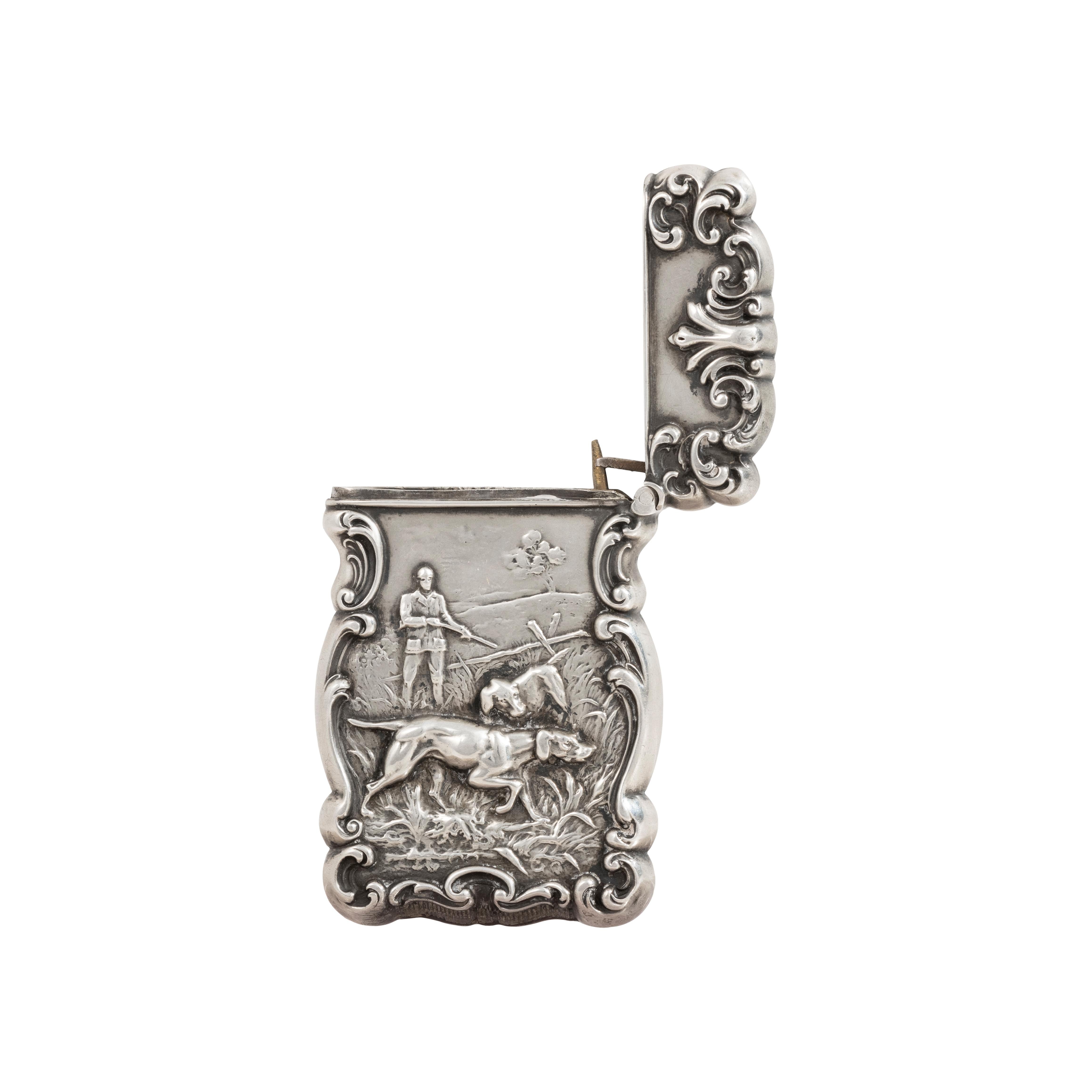 Sterling silver sporting match safe with etching. Two hunters with a pointer on point. In the early 1900s smoking could now move outdoors and become part of the outdoor sporting life. The match safe is decorated with a sporting theme popular with