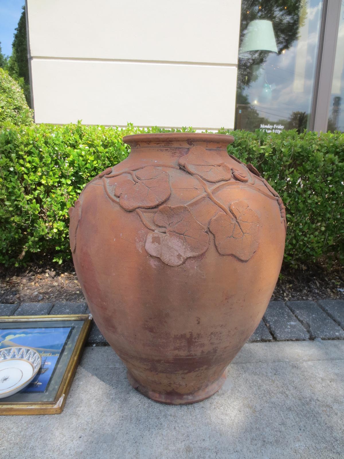 Terracotta urn / vase with grape leaf detail, circa 1900.