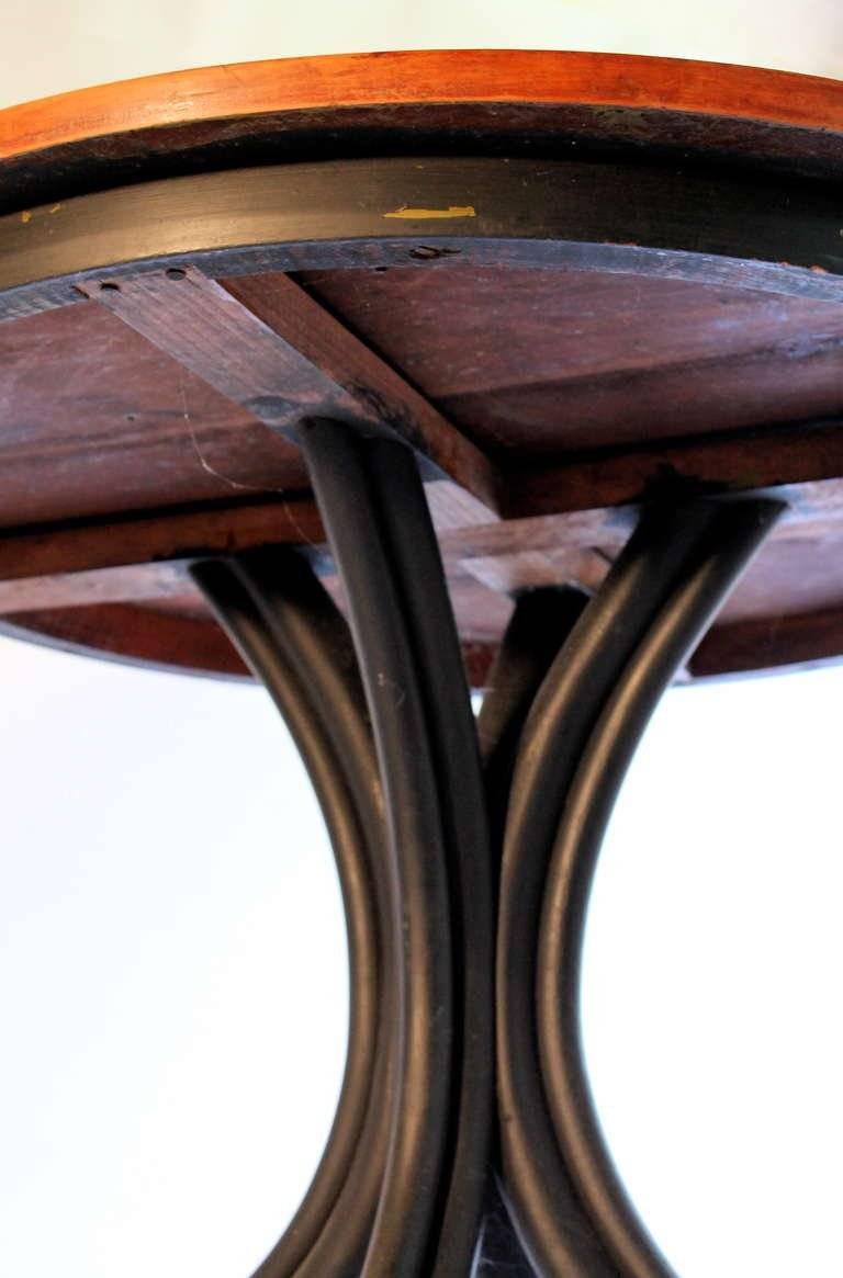 An Austrian bentwood table designed and manufactured by Thonet, circa 1900. Black legs with a natural surface to the tabletop. Measures: Height 30