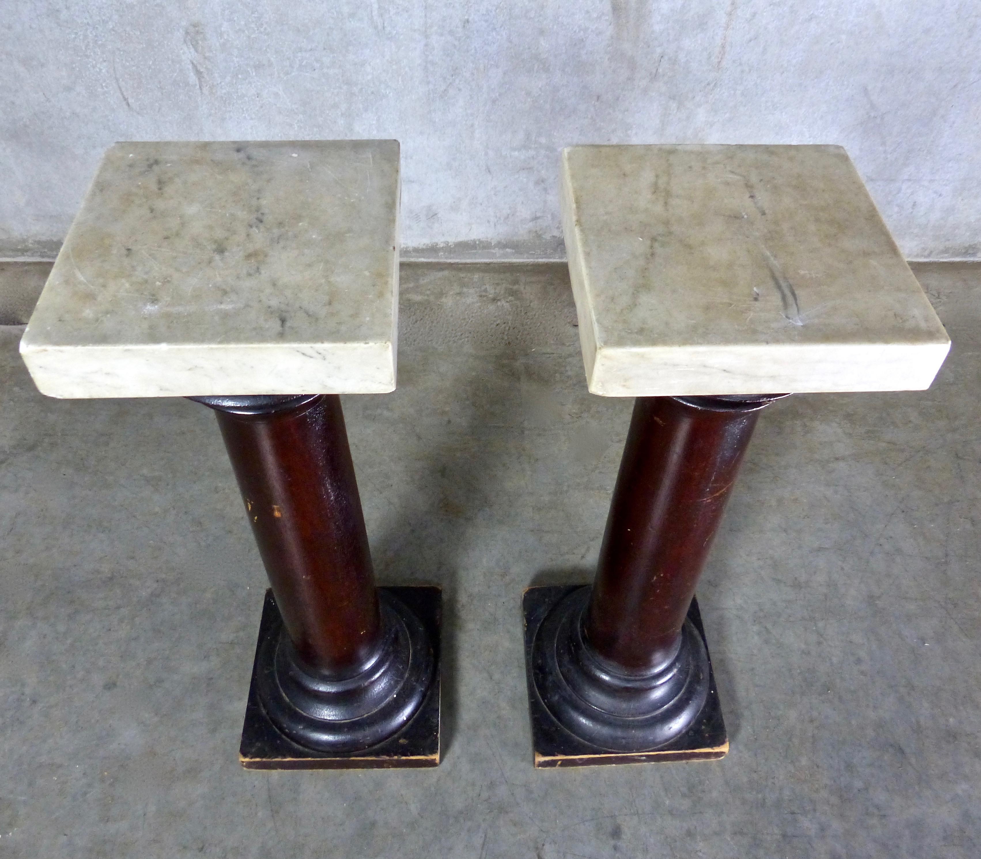 Matched pair of clean-lined mahogany columns/stands with built-in bases. And retaining original painted surfaces, circa 1900. Detachable tops made of thick slabs of squared marble. Use the pedestals as accent columns or display stands.
Dimensions:
