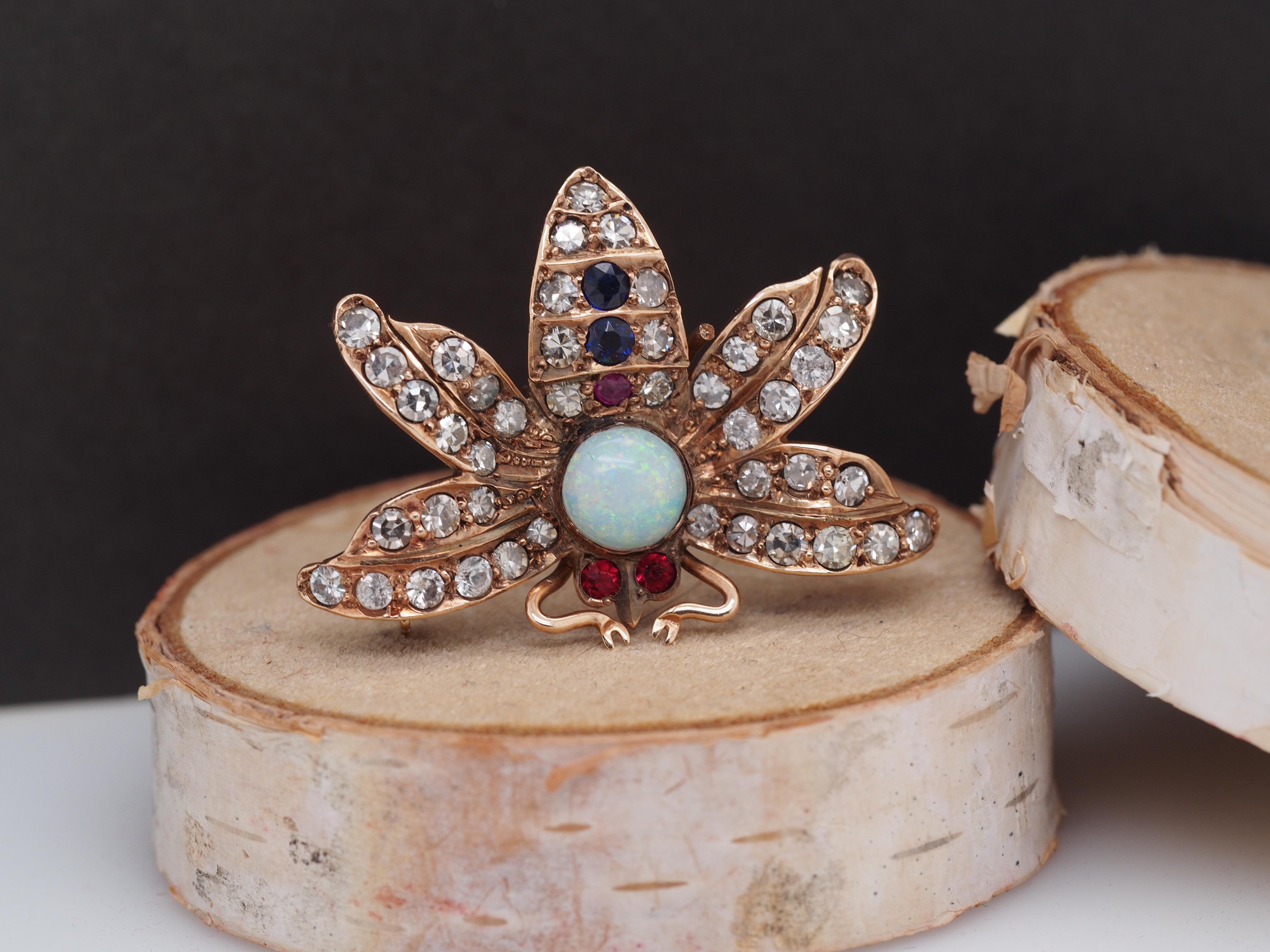 Year: 1900s
Item Details:
Metal Type: 14K Yellow Gold [Hallmarked, and Tested]
Weight: 4.6 grams
Diamond Details: .70ct, total weight. Antique single cut. G-H Color, VS Clarity.
Opal Details: Natural, Round Cabochon Shape, .80ct
Ruby and Sapphire