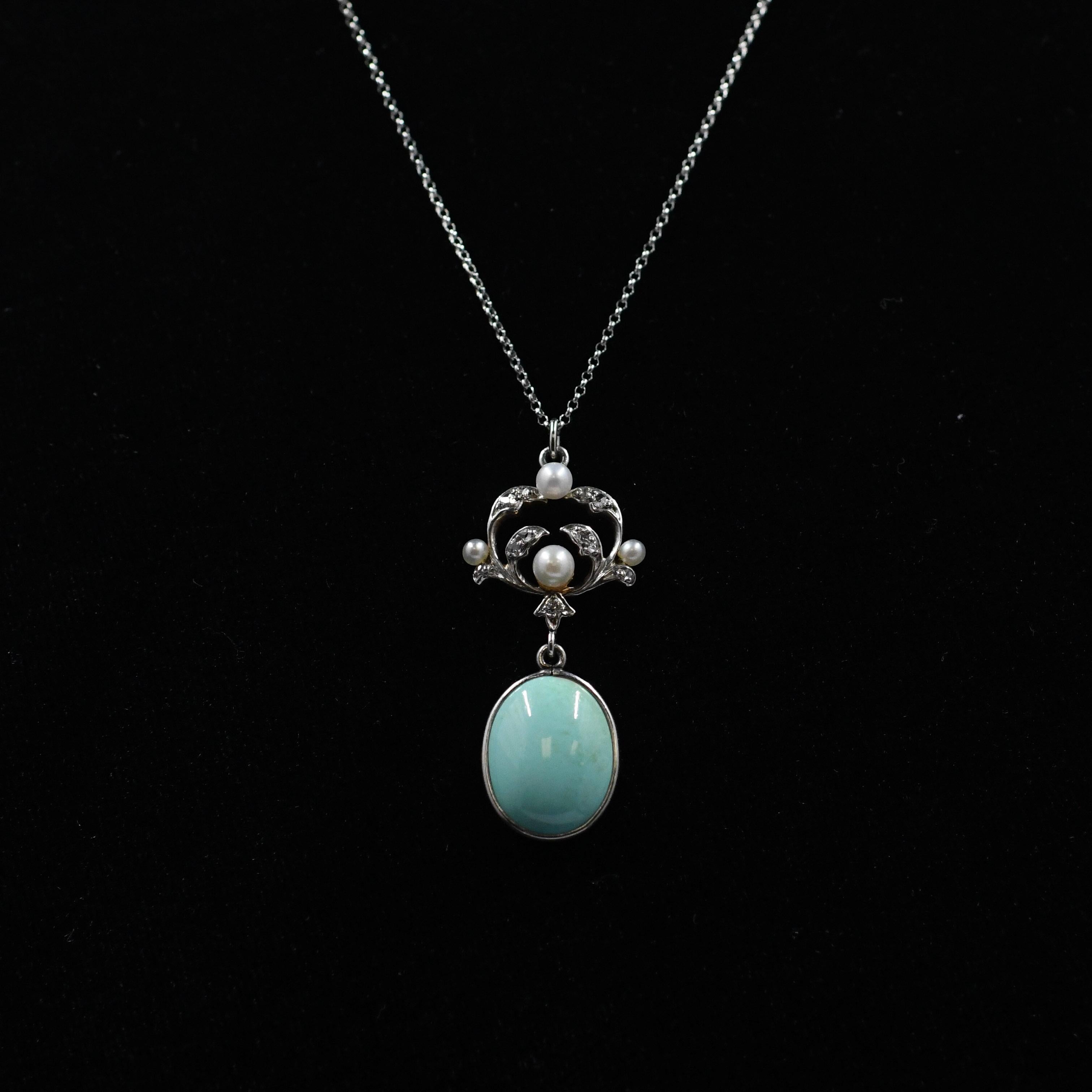 Indulge in the beauty of this Art Nouveau pendant, adorned with exquisite details and crafted with precision. A captivating turquoise drop delicately accents the piece, adding a touch of vibrant allure.
Enhancing its allure further, ornate diamond
