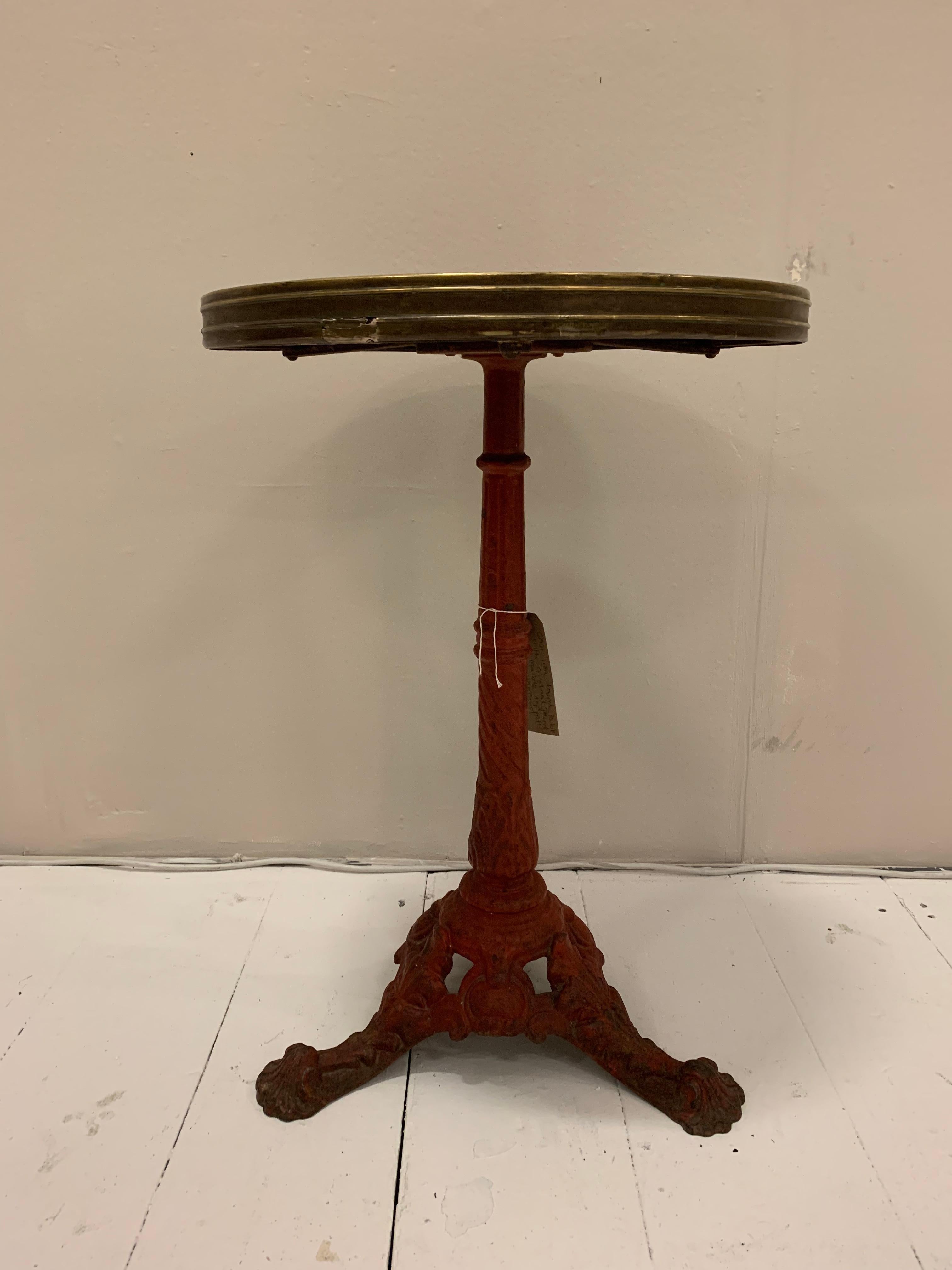 Very good quality French bistro cafe table, circa 1900s

The cast iron base has historic deep red paint with a decorated central column with three splayed feet with interesting scallop detail.
The circular marble top is bound in a reeded brass