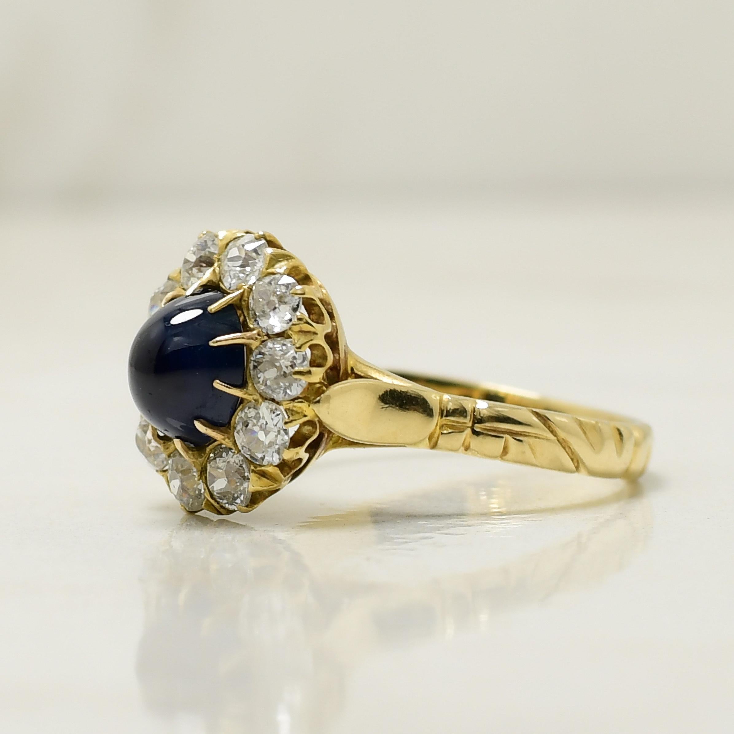 This ring is a testament to exceptional craftsmanship. Fashioned in lustrous 14K yellow gold, it showcases an organic engraving starting at the shank and gracefully wrapping around the finger, leading up to the cathedral shanks. In the heart of
