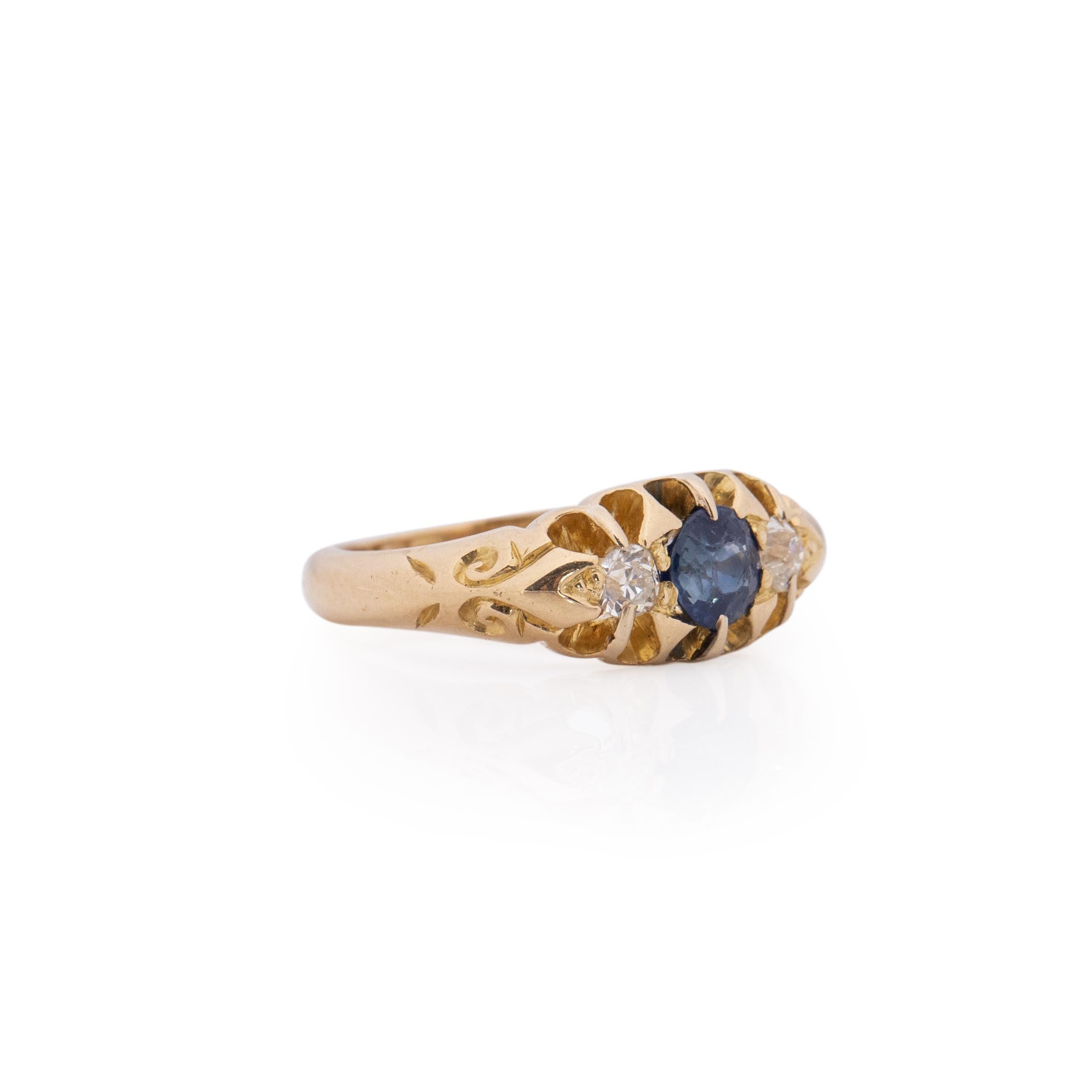 This Victorian ring has a beautiful pop of color with a vibrant blue sapphire showcased right in the center of two beautifully cut diamonds. Crafted in 18K yellow gold this color is the perfect contrast the the sapphire. This ring would make a