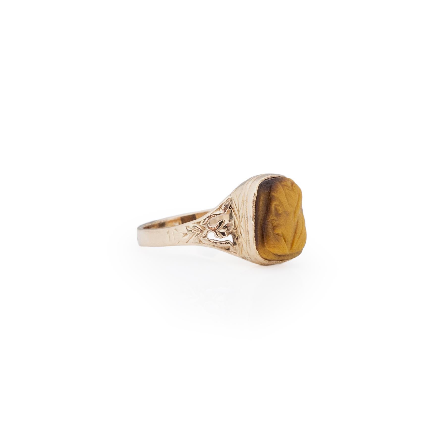 This Victorian treasure is a unique find. The 9K hand carved split shank design holds a beautiful rectangle tigers eye. On the tigers eye is a delicately carved cameo. This a figure has feminine characteristics, a true work of art. This piece is one