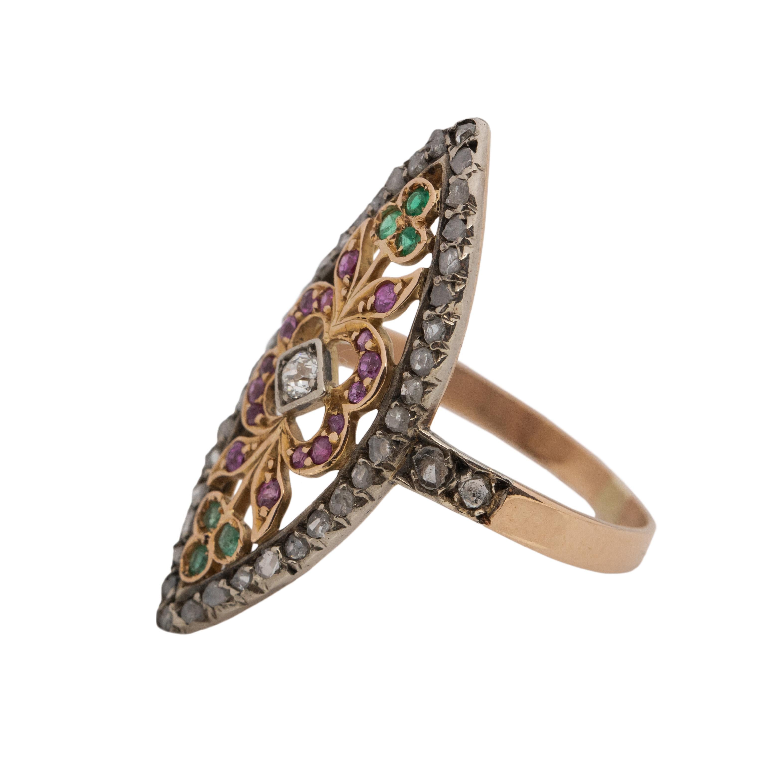 This Victorian piece is full of color, and is classically designed for its era. The simple smooth shanks hold the elongated Navette shape, surrounding the design are rose cut diamonds set in white gold. In the center of the diamonds is a yellow gold