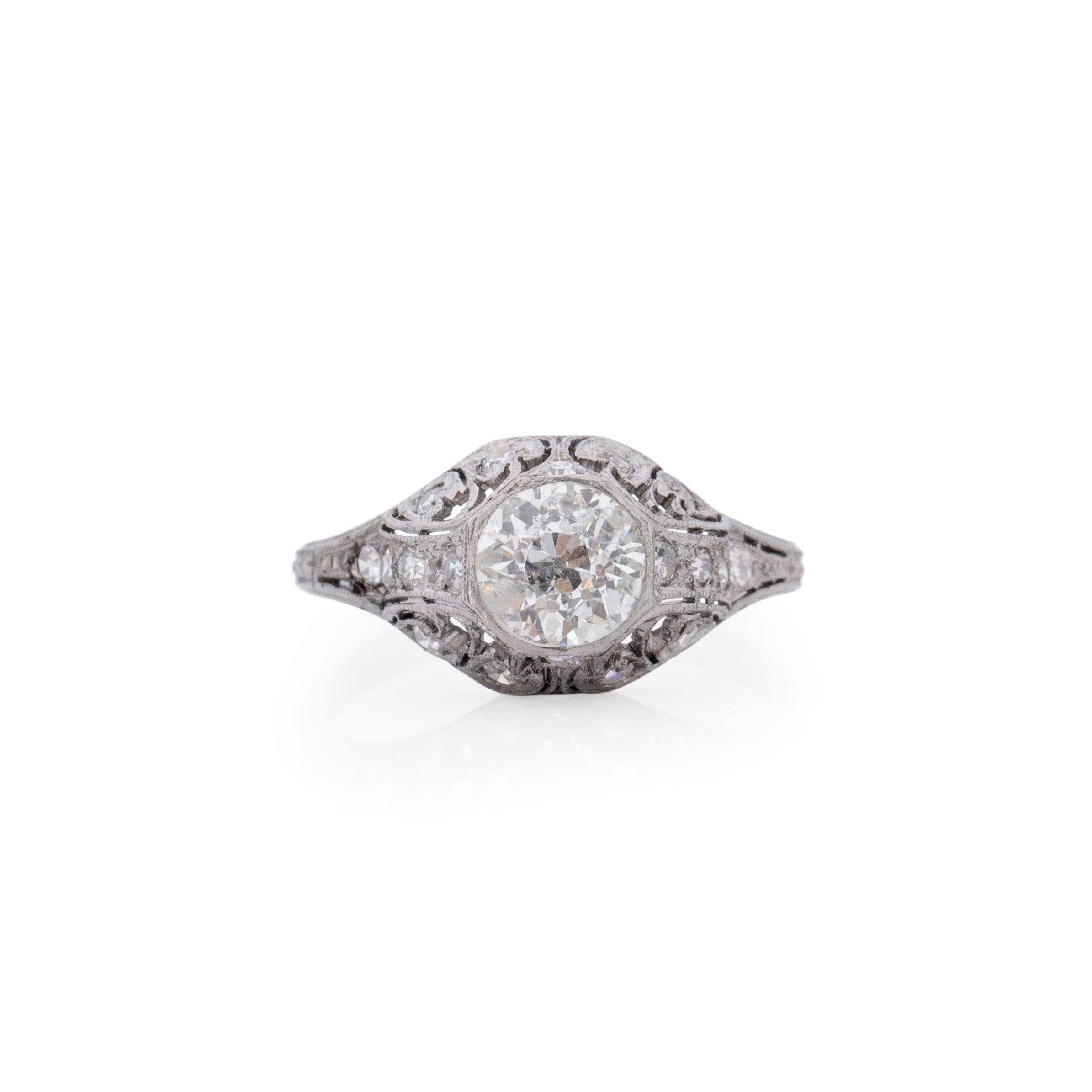 A testament to the elegance of the Edwardian era, this antique masterpiece is set in platinum and features a resplendent old European cut diamond as its centerpiece. Encircled by 16 dazzling accent diamonds, it exudes a classic Edwardian charm. The