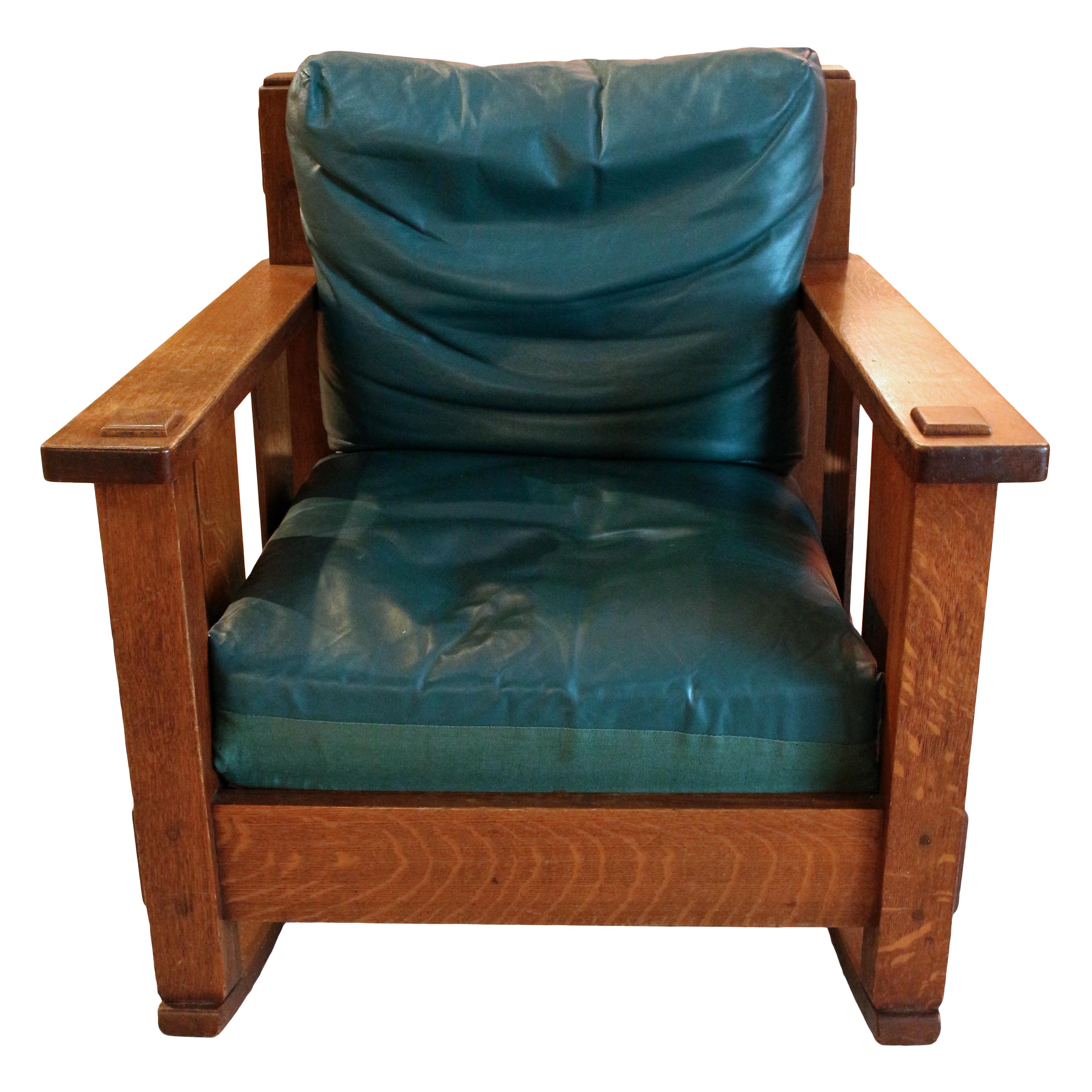 Stickley rocking arm chair, circa 1902. Removable cushions in blue-green leather. 1902 label: 