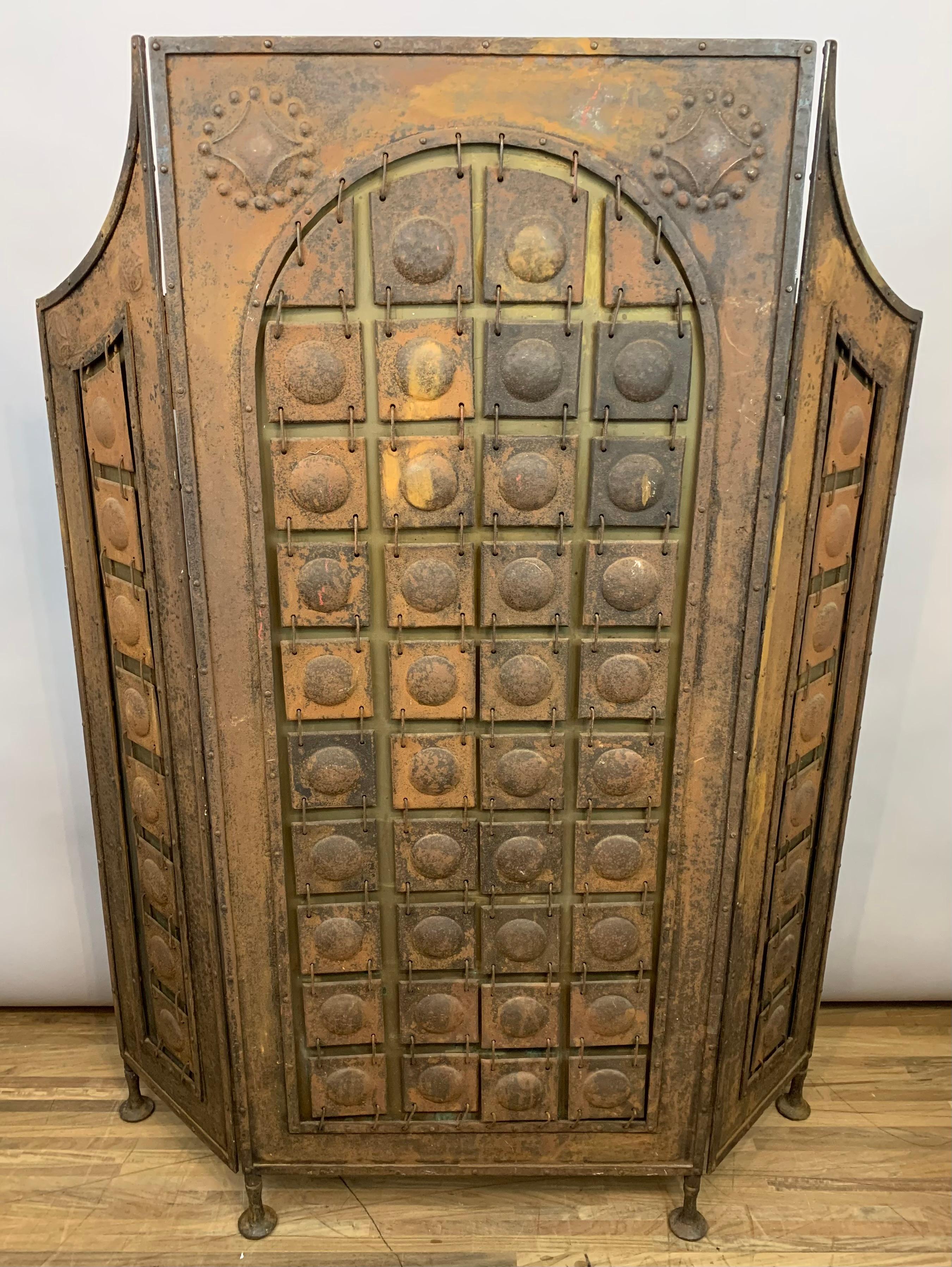 An intricately designed, and well-made, Arts & Crafts iron screen, attributed to and almost certainly designed by Richard Riemerschmid (1868-1957) in Germany. Circa 1910. The iron screen has a one large rectangular panel with two smaller stabilising