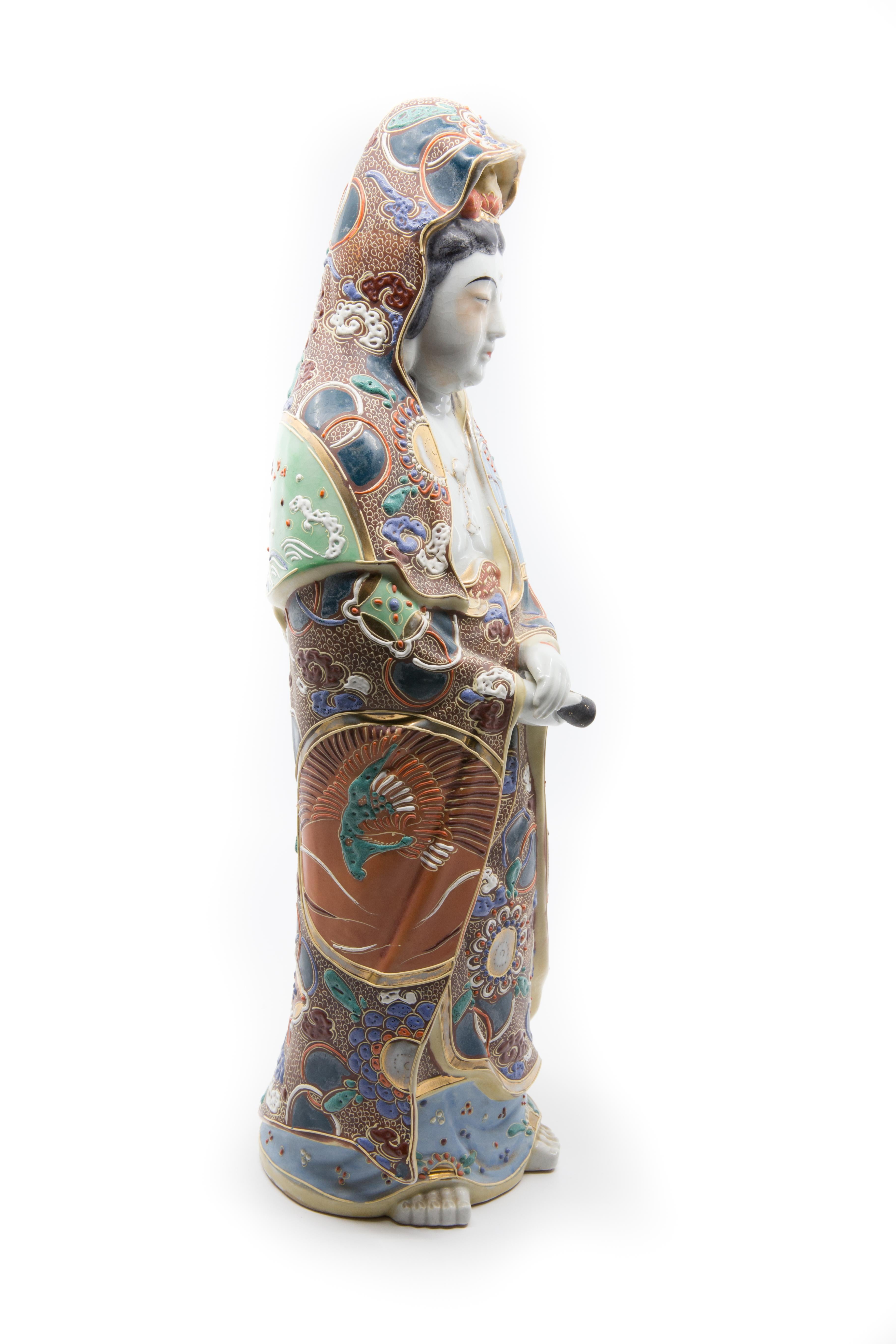 Offered is a tall circa 1910 Kutani porcelain decorated figure of a robed noble woman carrying a staff of office. The figure stands approximately 16” in height and is in good condition with no losses.