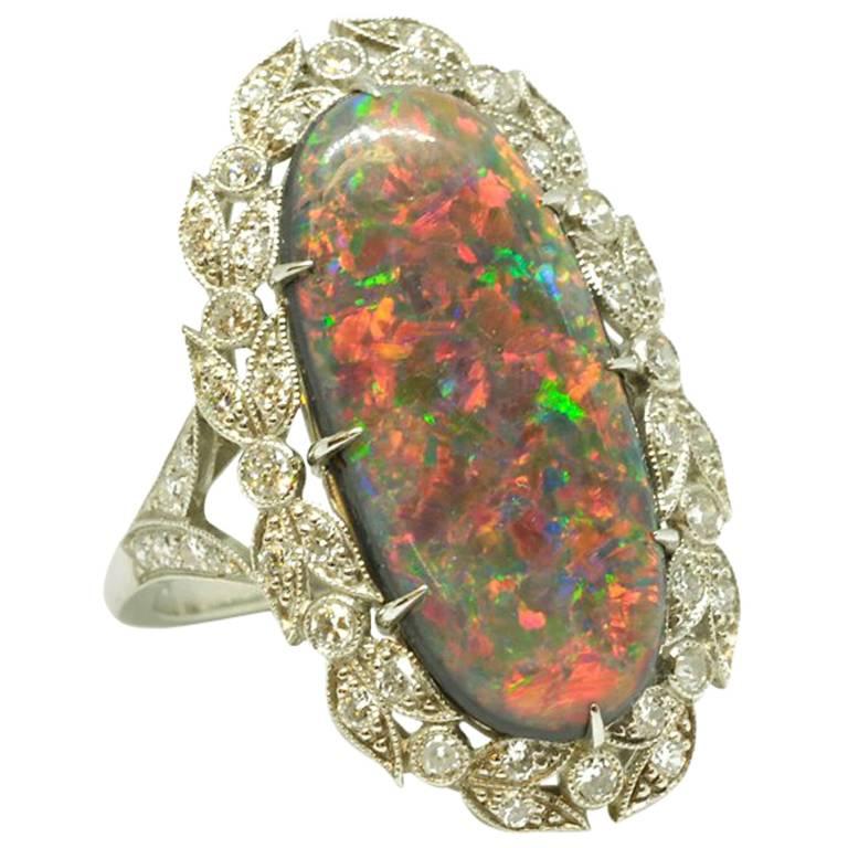 Circa 1910 Edwardian Black Opal and Diamond Platinum Cluster Ring