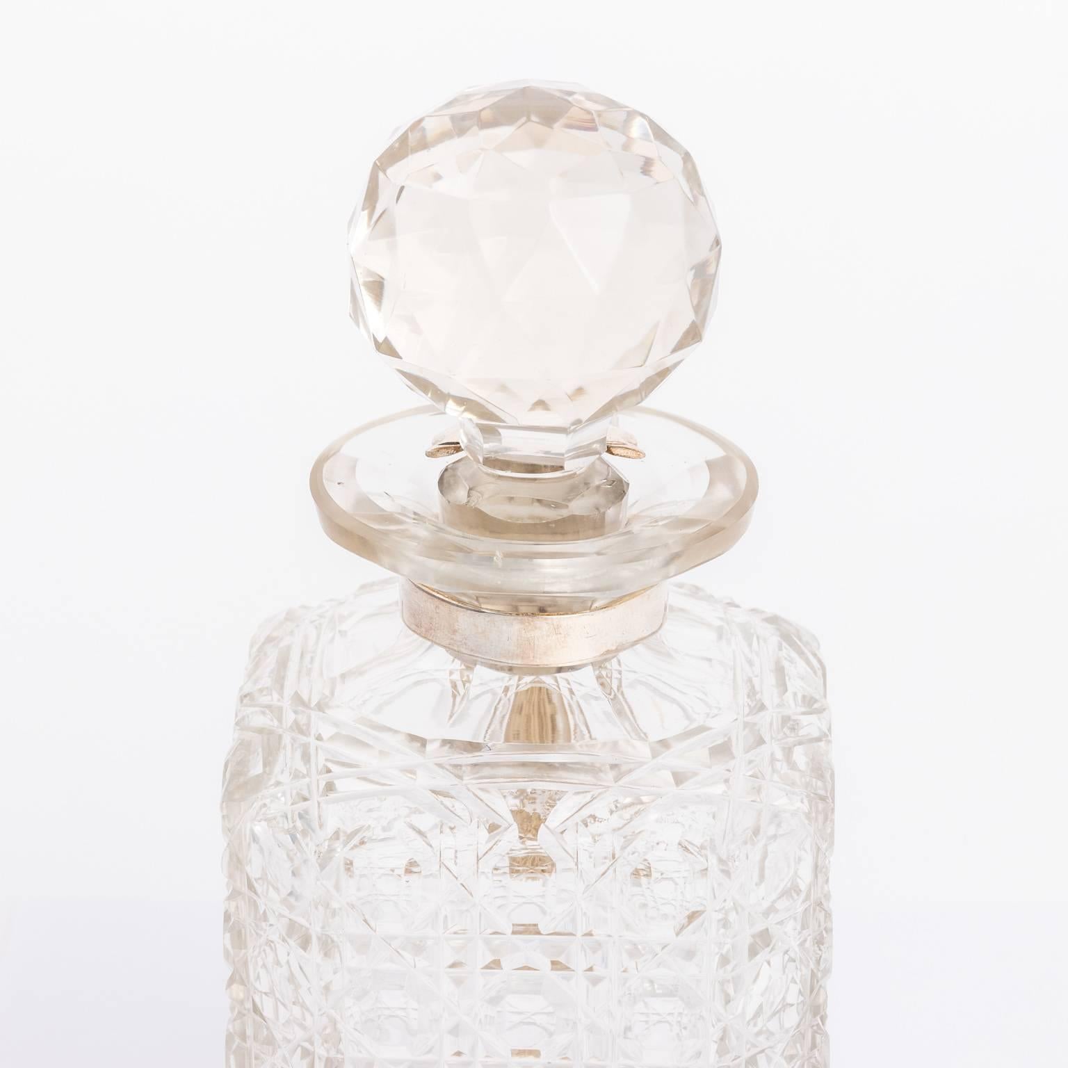 Circa 1910 English decanter with working lock in a cut crystal finish.