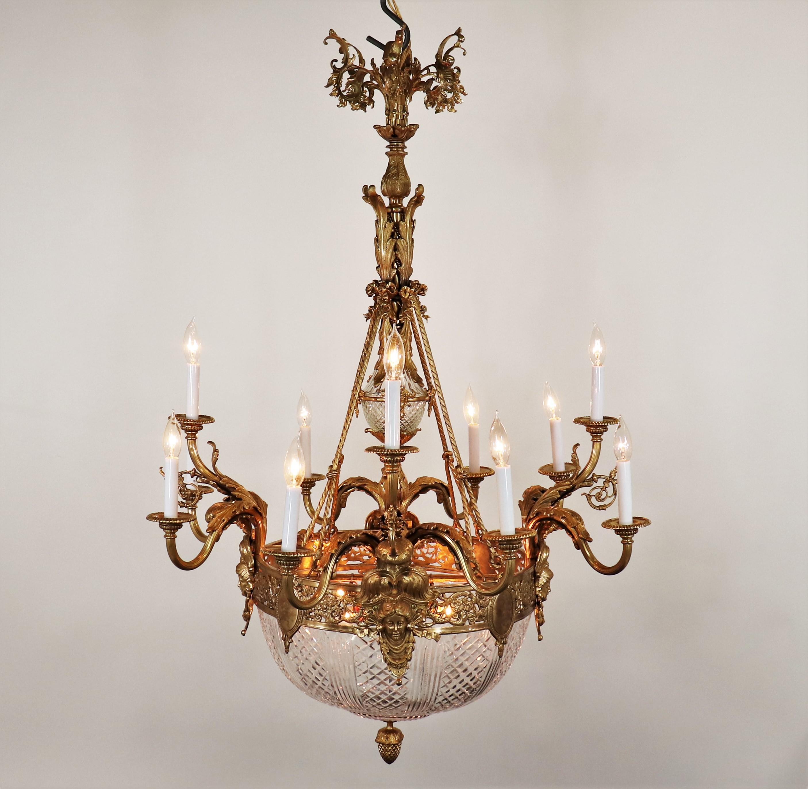 Large Circa 1910 French Beaux-Arts gilt bronze chandelier. Finely cast French bronze chandelier in the fashion of Louis XV. This wonderful chandelier has a large cut crystal center bowl. With intricate uniform Rococo and Neoclassical bronze