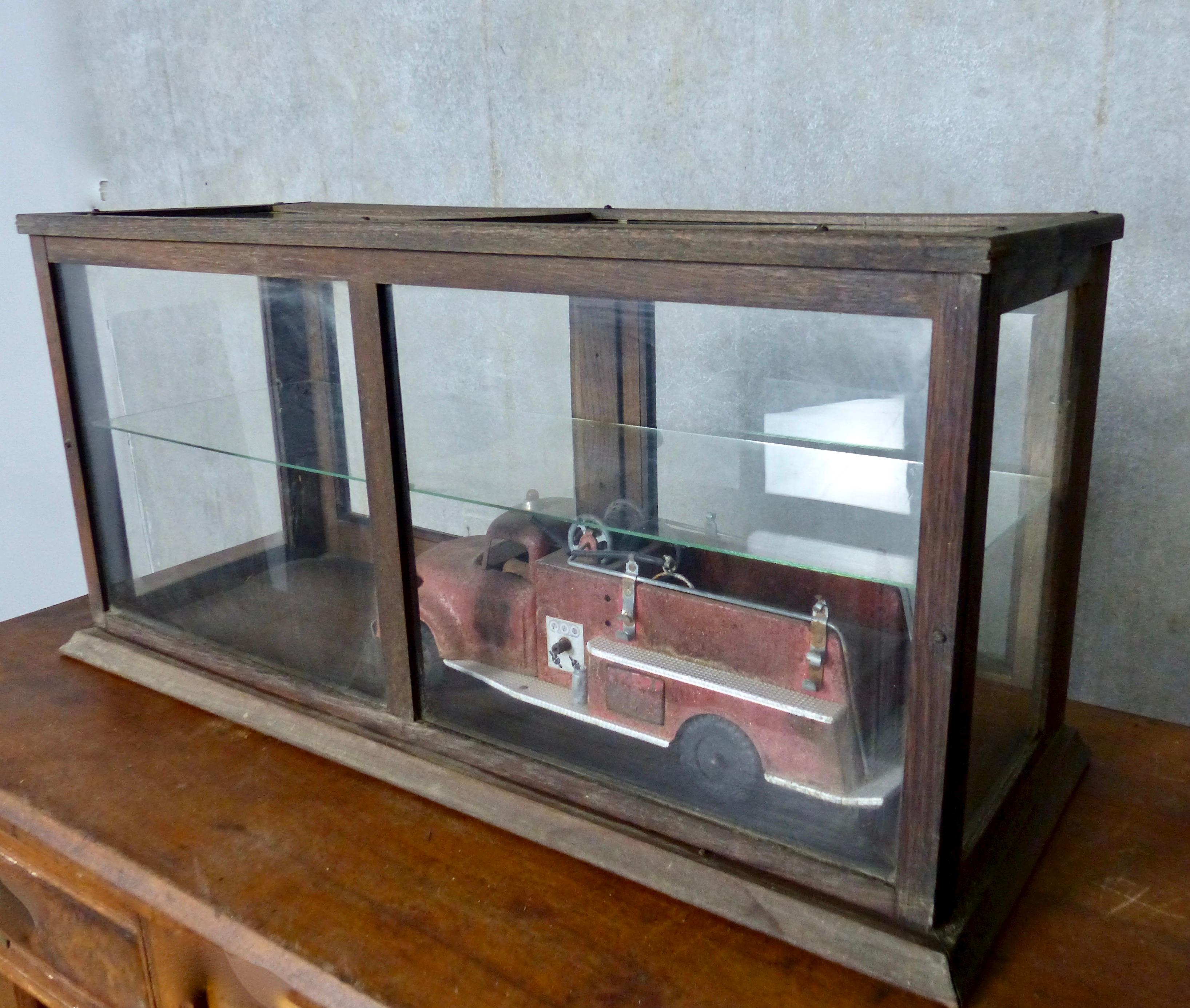 Fully glassed-in tabletop retail display cabinet. Solid oak frame; glass top; two doors in rear of case. A clean-lined case to house a unique collectible.
Dimensions: 15