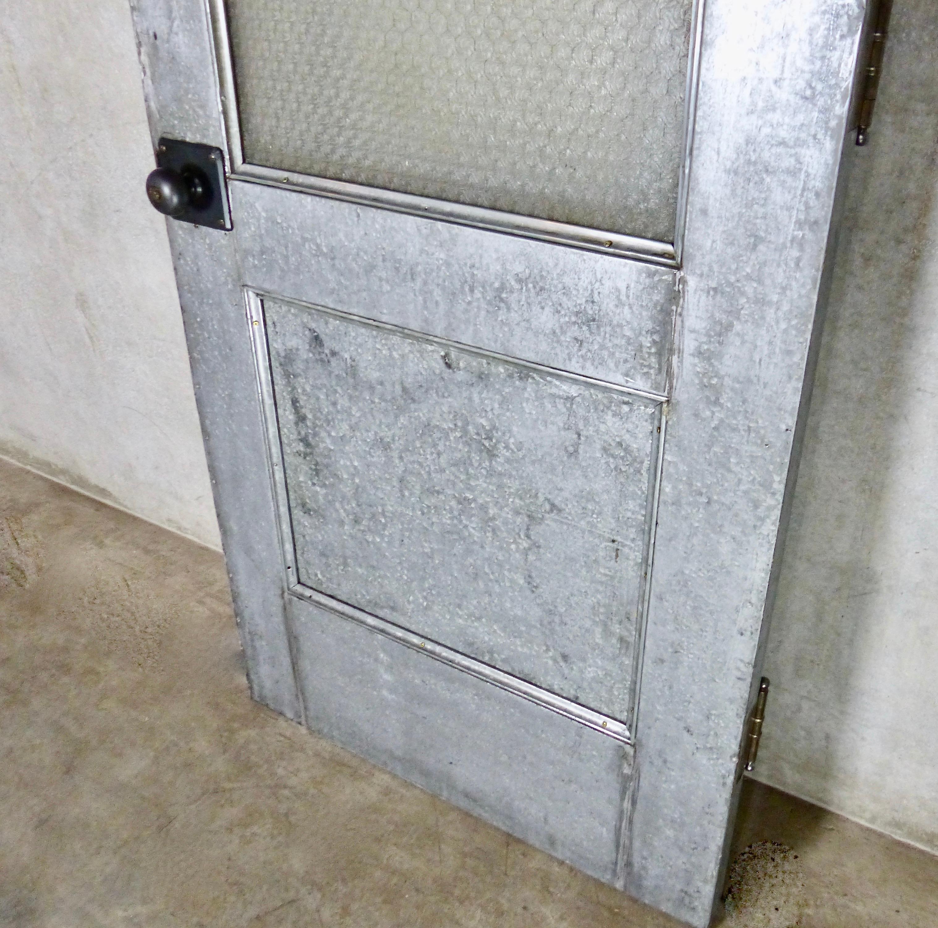 A handsome galvanized steel door from circa 1910 — with its original and unusual etched chickenwire glass intact. Nice old nickel hinges and handles as well. A high visibility, high impact interior or exterior door.
Note: we have the original jam