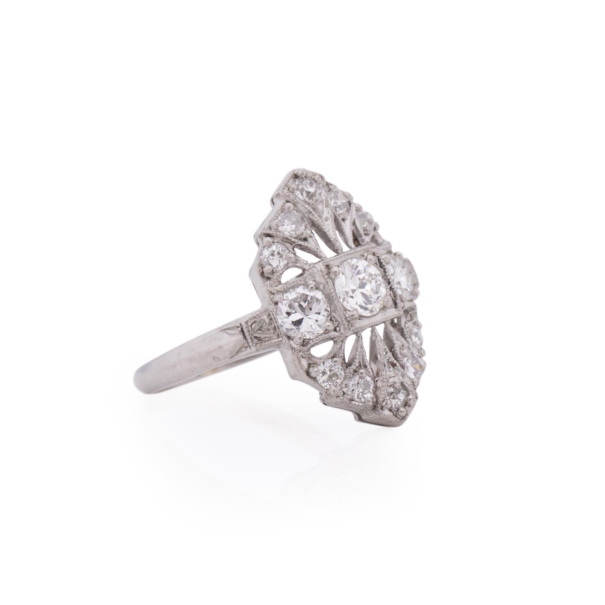 A sweet little shield ring with a big vintage feel, this Edwardian ring has a beautiful flapper feel. The two arches at the top and the bottom of the three center stones give the ring length and outstanding detail. The three center diamonds are