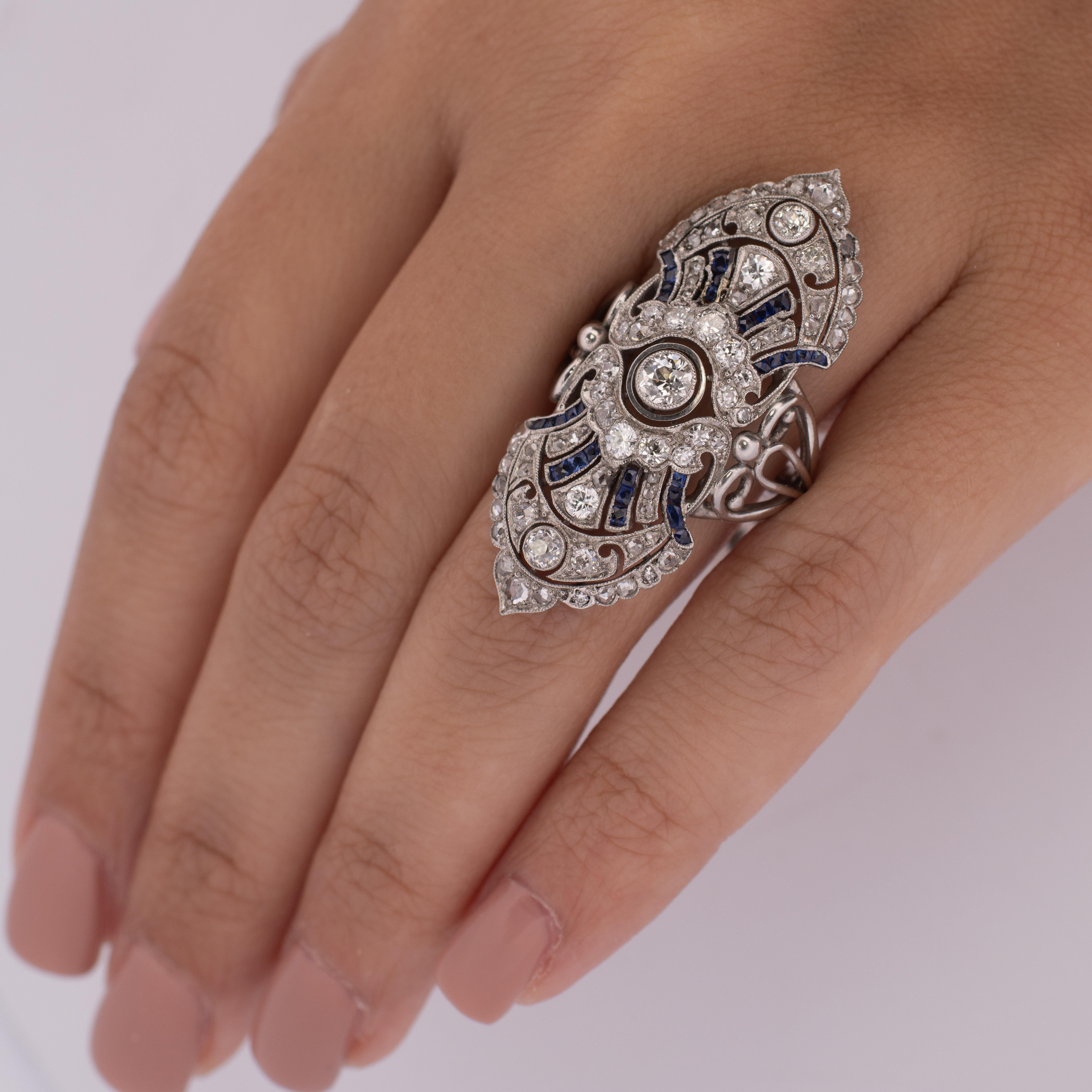 Presenting an impeccably transformed piece—an early 1900s brooch artfully reimagined into an extraordinary statement ring. The captivating shield design, masterfully forged in platinum, showcases a mesmerizing ensemble of 1.73 carats worth of