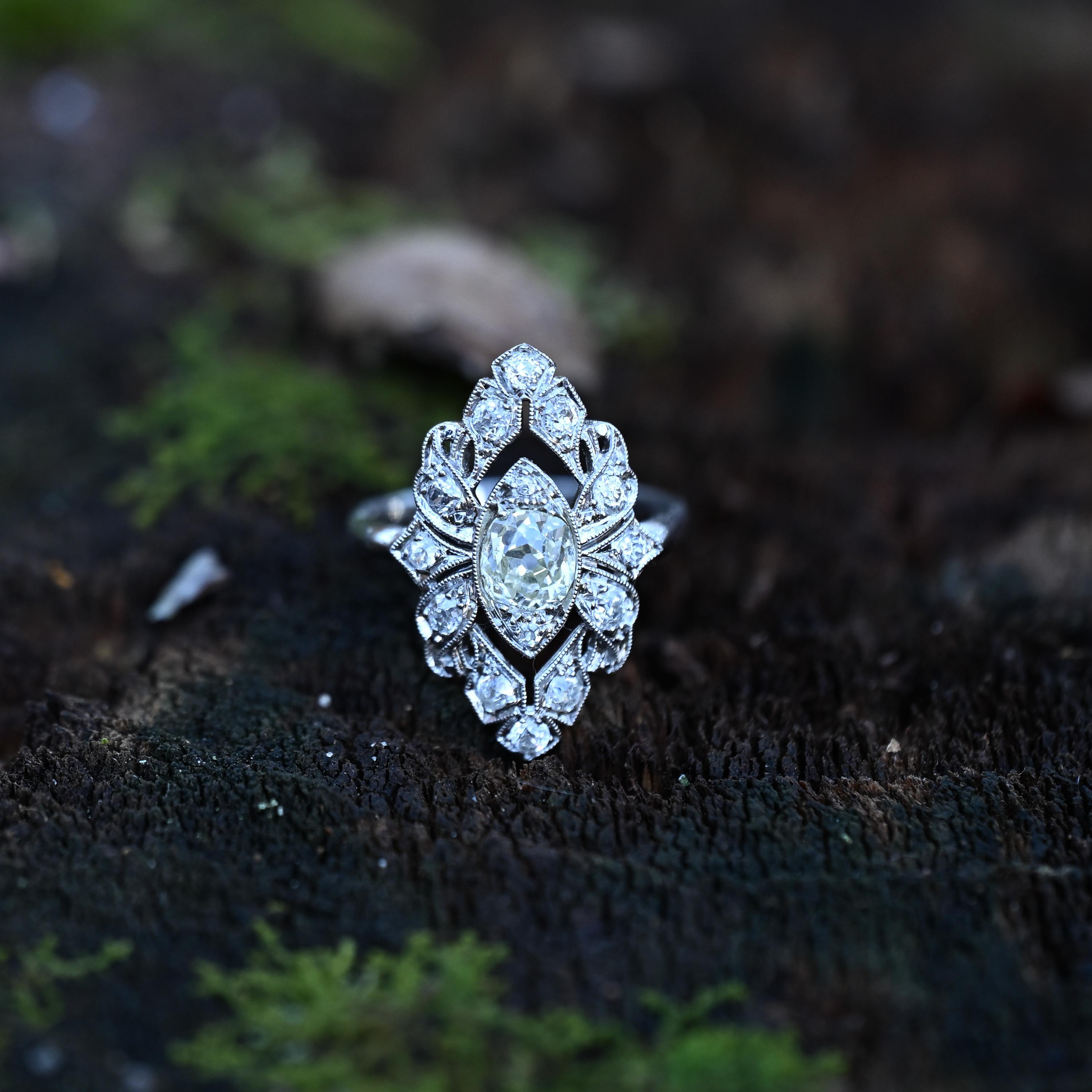 Presenting a truly captivating Edwardian marvel, this shield ring is a masterpiece crafted in platinum, showcasing exquisite detailing that evokes awe. From its delicate lace-like openwork to the dainty milgrain adorning each edge, every element has