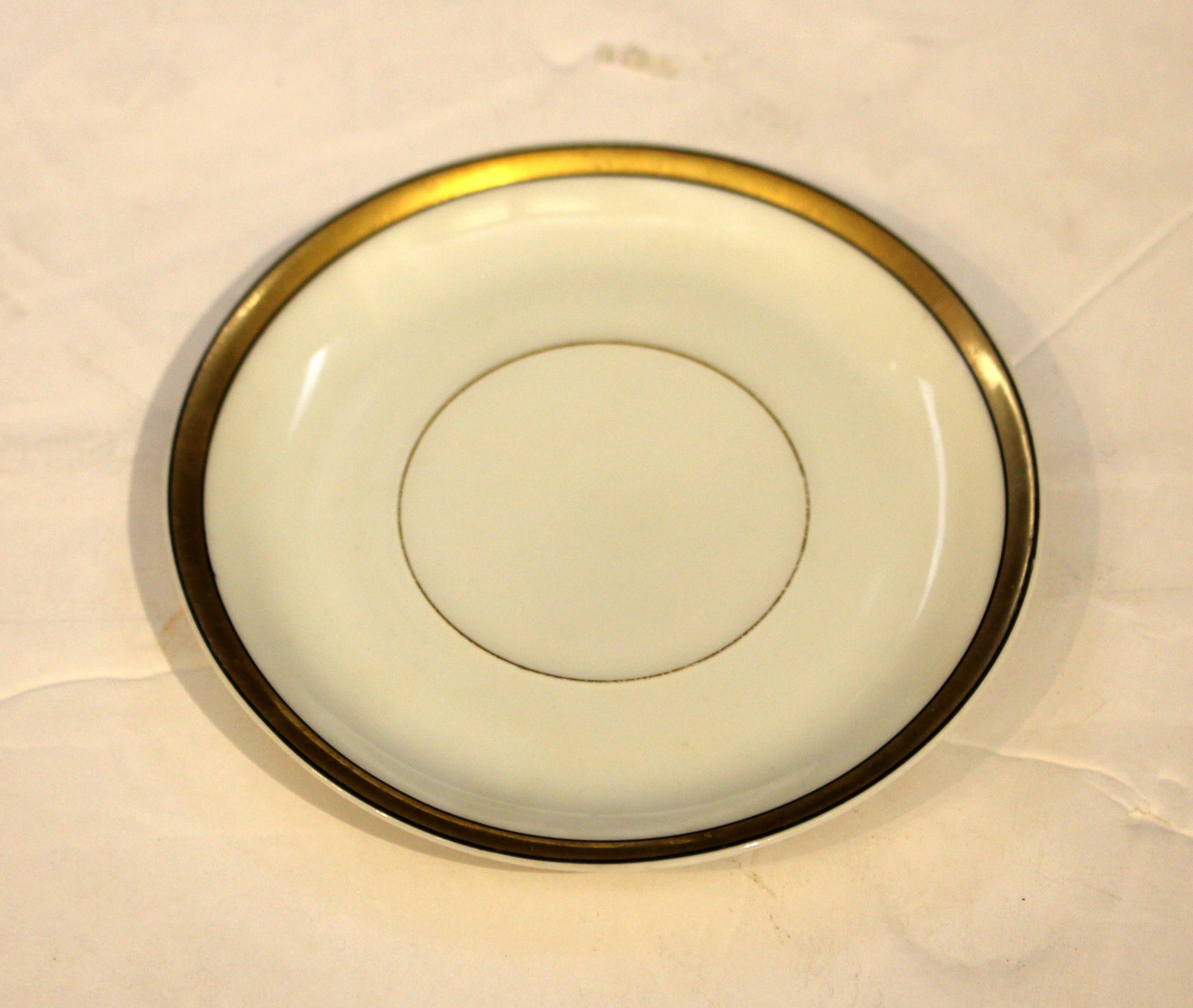 Circa 1915-30 set of 10 demitasse cups & saucers, Rosenthal's Donatello design. Art Nouveau-Art Deco transitional form set. Rare gilt & onyx band decor. Some wear, particularly to the small central gilt circle on the saucers, wear commensurate with