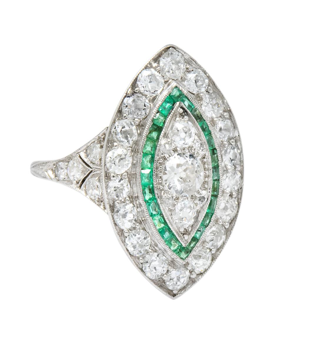 Designed as navette style dinner ring set throughout with old European cut diamonds weighing approximately 2.45 carats total, I/J color and VS to SI clarity

Accented by channel set calibré cut emeralds weighing approximately 0.50 carat total,