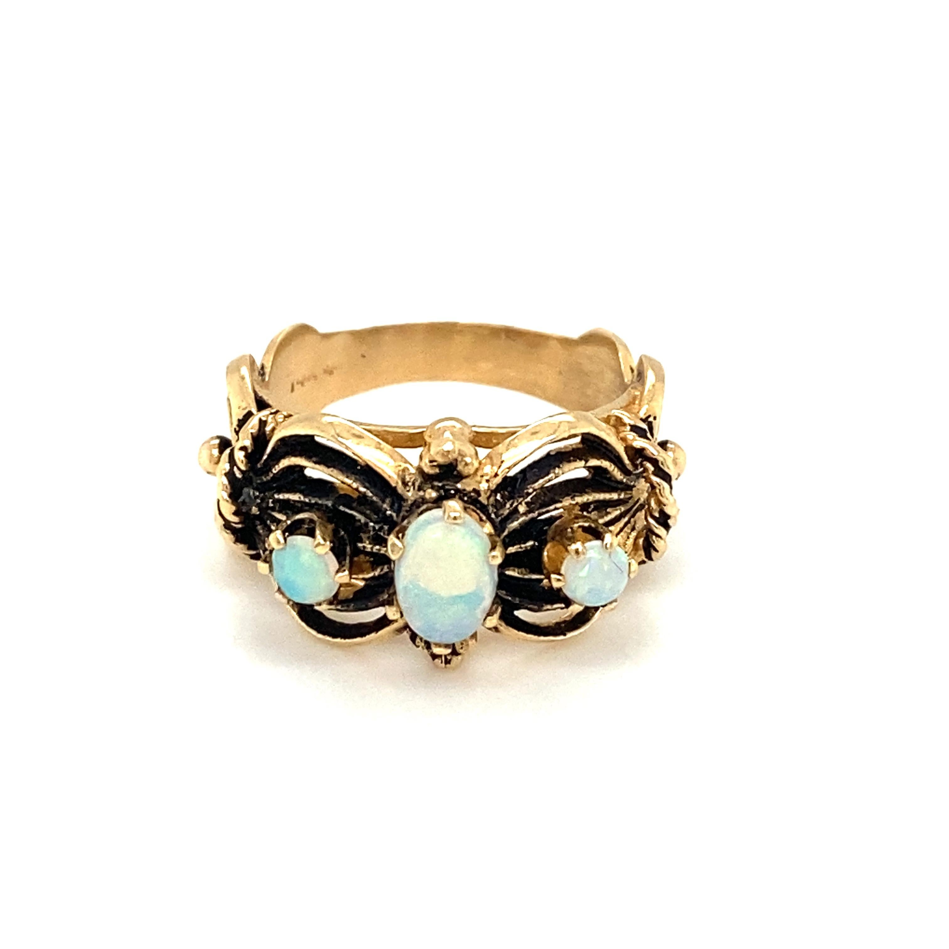 Item Details: This antique ring features three opals which originate from Australia.
The three opals have lovely color play ranging from orange to shades of green flashes.
Circa: 1915
Metal Type: 14k yellow gold 
Weight: 5.1g
Size: US 6.5

Opal