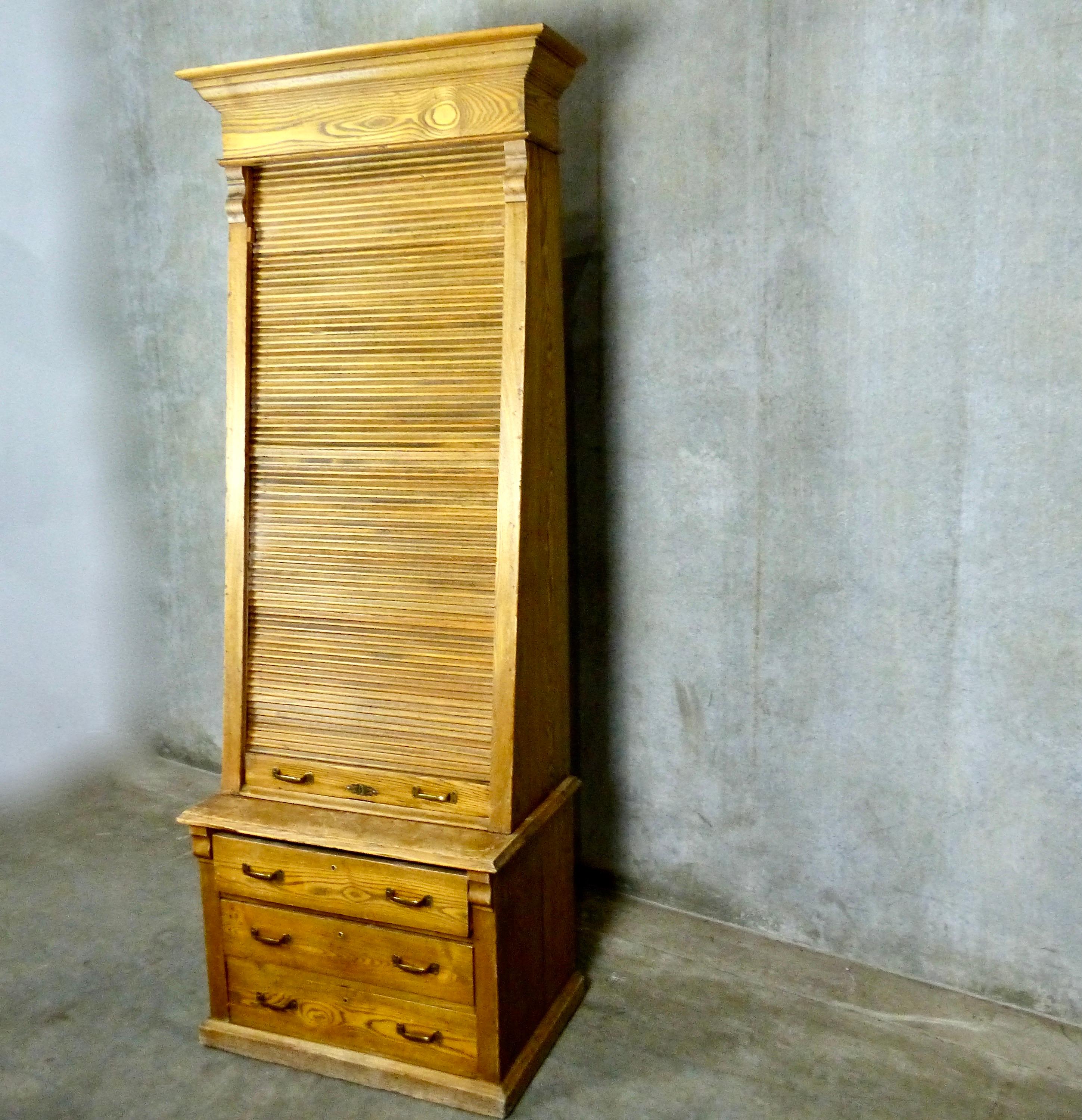 Railway ticket cabinet in solid oak with a unique roll down/tambour cover. Made by Poole Brothers in the USA in the 1920s-1930s. Multiple shelves plus three lower drawers with original brass hardware. Recently acquired from a private