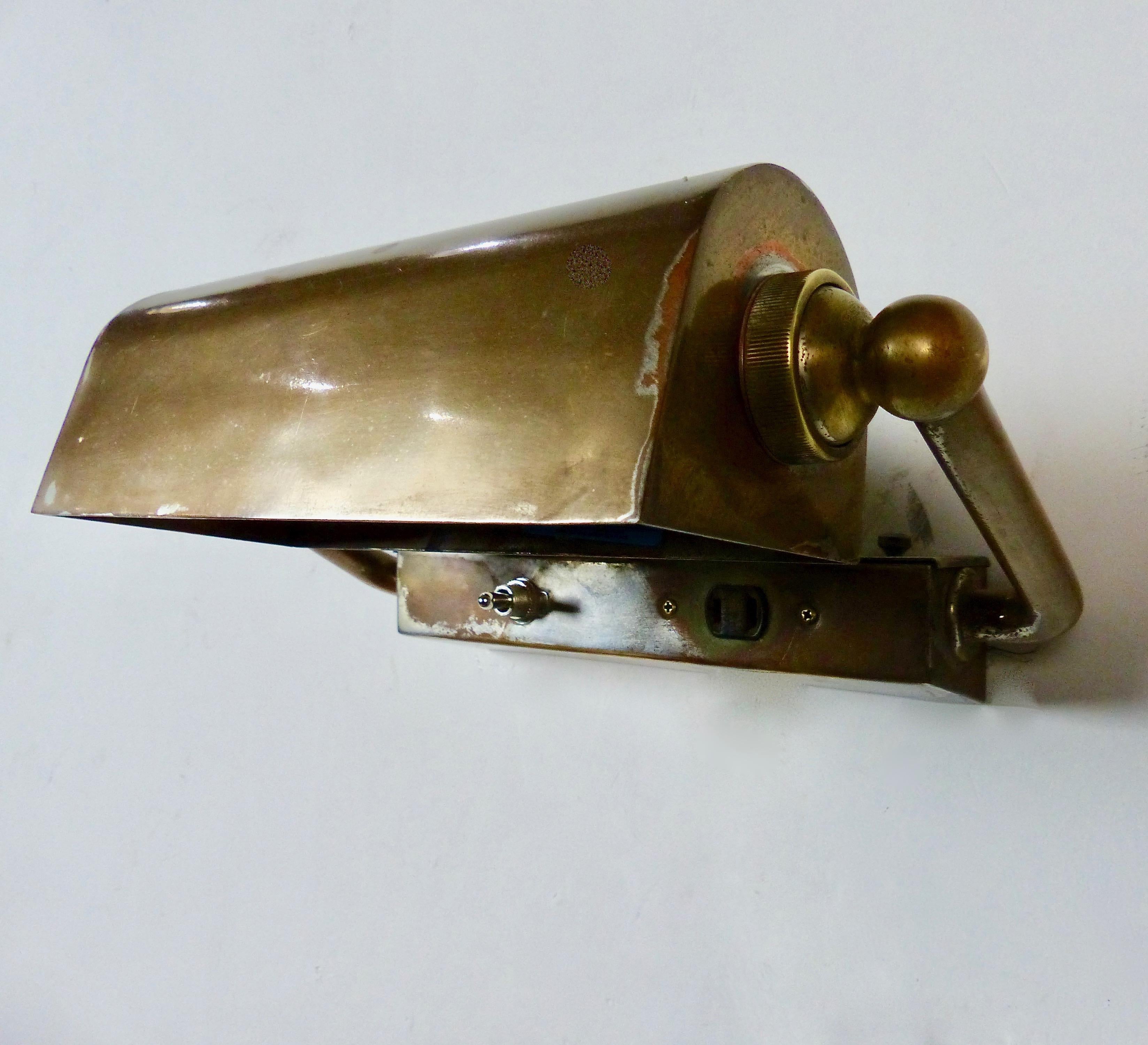 Brass picture-style, wall-mounted lights with articulating hooded shades, circa 1920. Attractive cast brass support arms. Re-wired and CSA approved to current electrical standards. Price per light.
Dimensions: 8” H x 112” W x 7” D
Rare form. Very