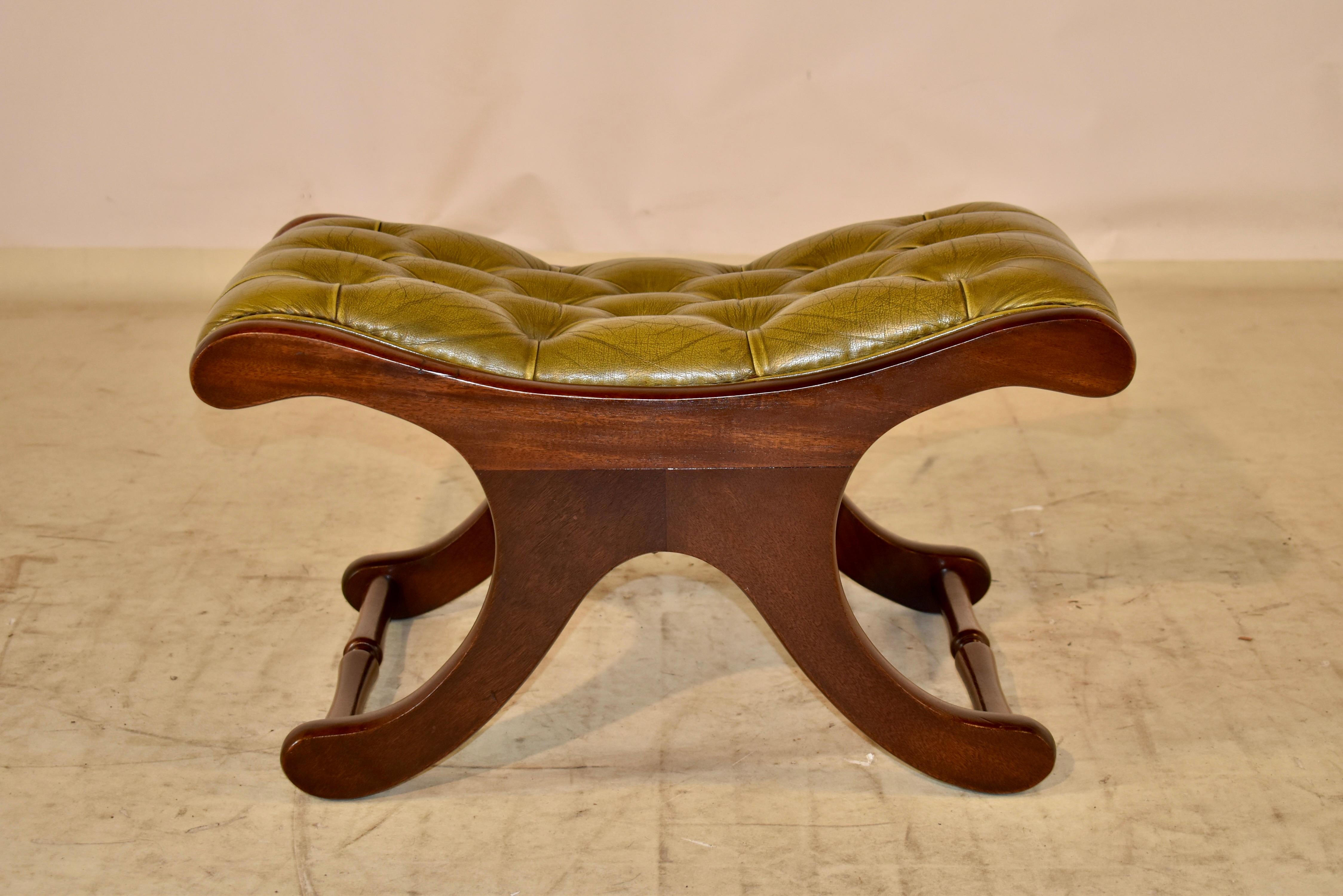 circa 1900-1920 mahogany stool from England with a green leather seat. The leather is original and is upholstered in an attractive Chesterfield pattern. the frame is lovely and shapely, with an x type stretcher base. The legs are joined by hand