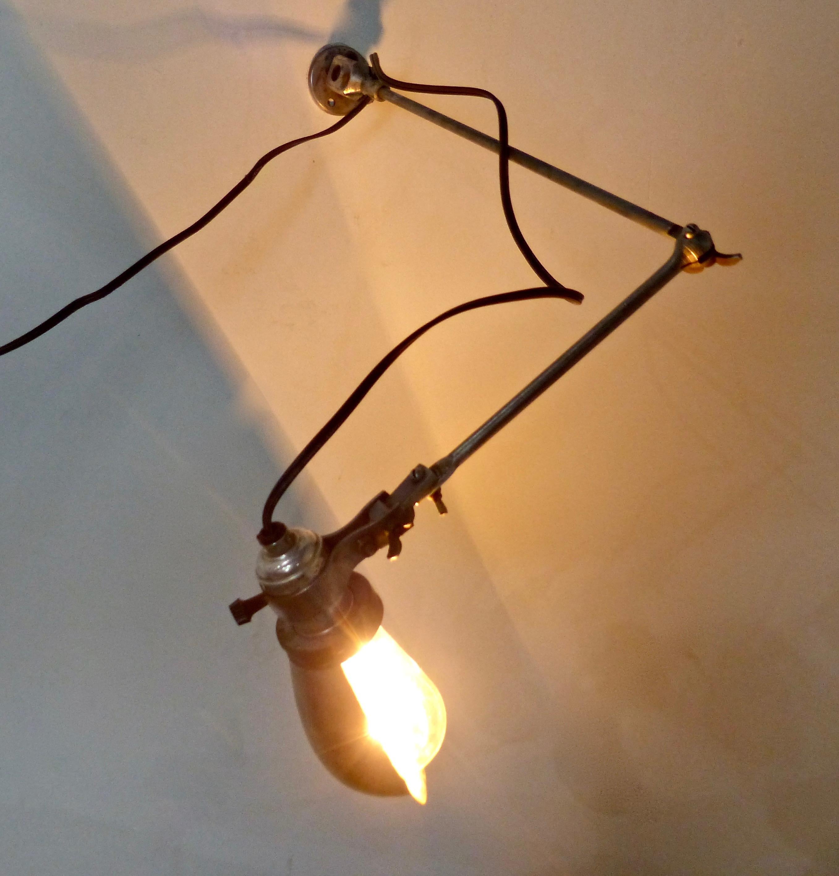A white metal, wall-mounted articulating wall sconce from circa 1920. Re-wired and fully functional.
Dimensions 24”W (fully extended); shade 4” x 4”