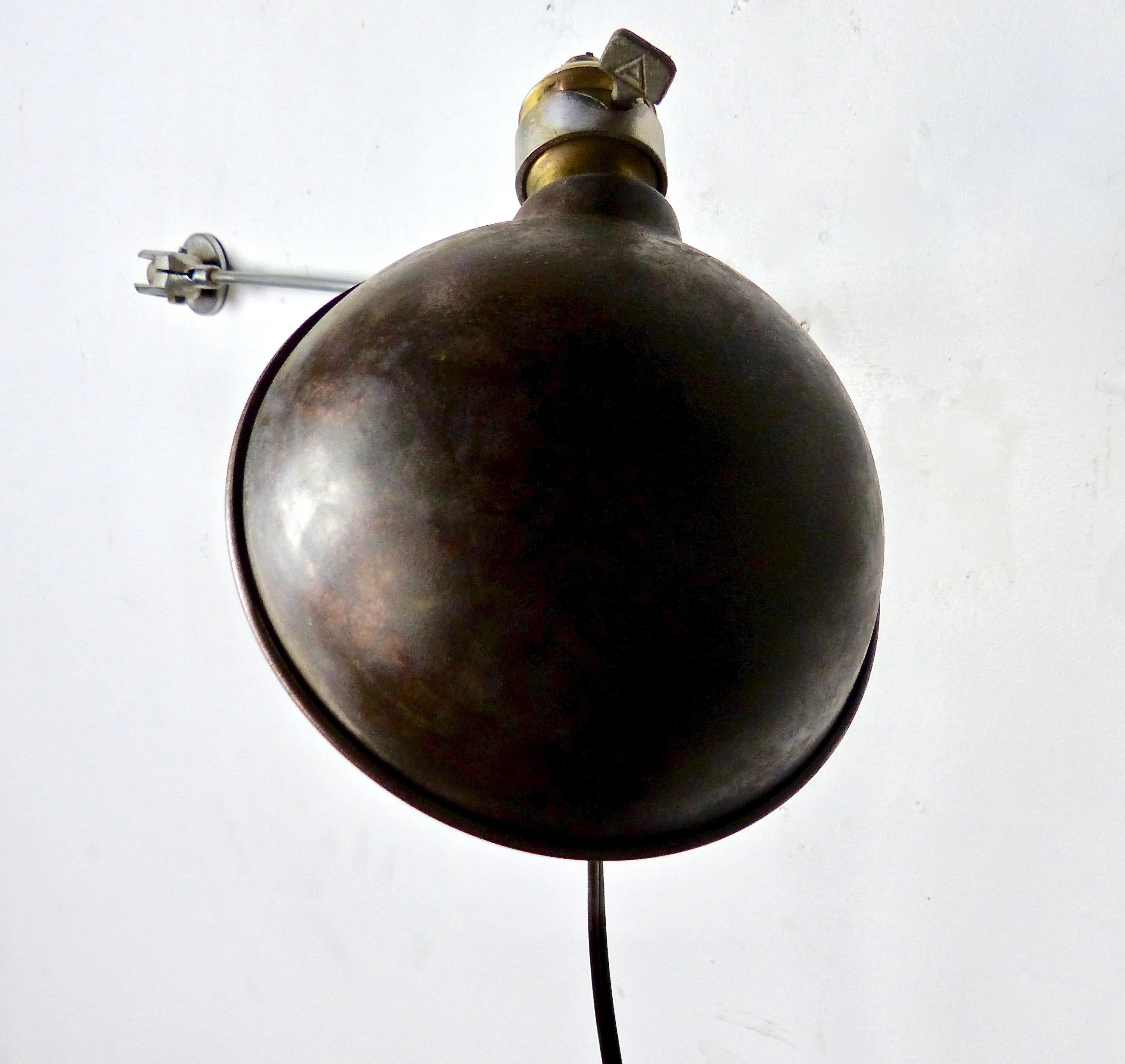 A circa 1920 articulating wall sconce with a copper shade and interesting steel hardware. Re-wired and CSA approved to current electrical standards.
Dimensions 24” width (fully extended) x 6” diameter.