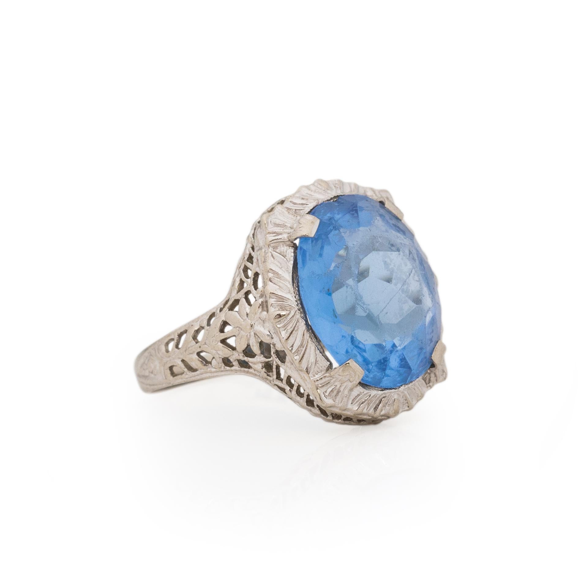 Here we have a art deco classic, in the deco era not everyone could afford, and some did not care if it was a gem or not. The beautiful blue stone is glass, the vibrant color is breathtaking. The facets that are cut in catch the light giving you a