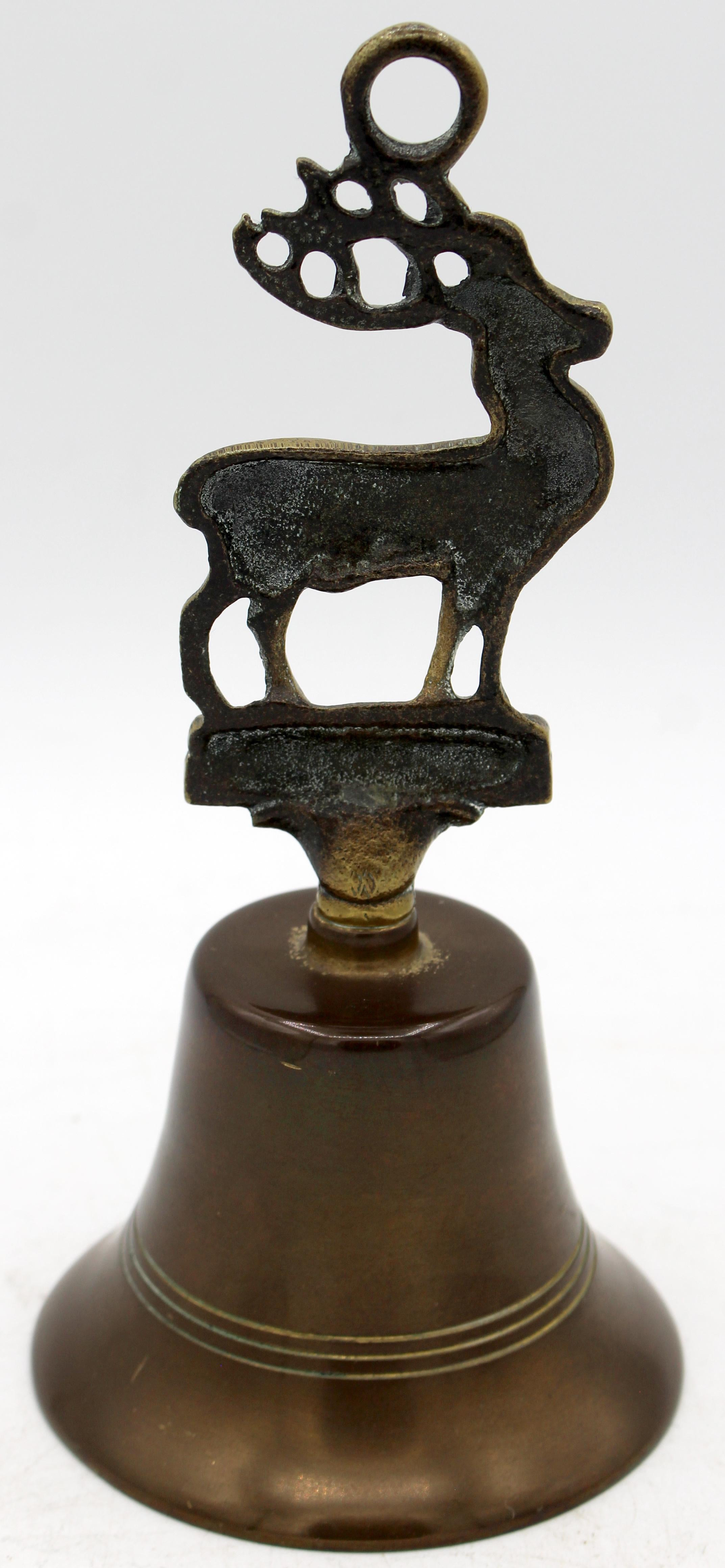 Circa 1920s-30s English stag motif brass table bell. Ring etched bell. Acanthus foot under base of very well developed stag.
7