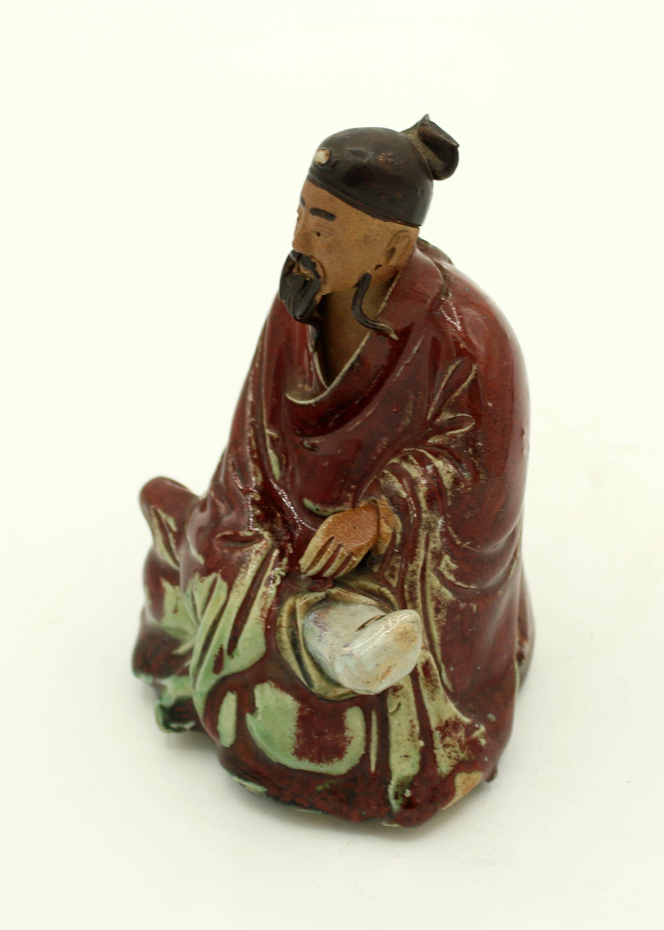 Circa 1920-30s Shiwan pottery seated figure. Finely modeled; rich colored enamel glazing. Comparable to several examples in the British Museum collections. Exceptional work. Measures: 4 5/8