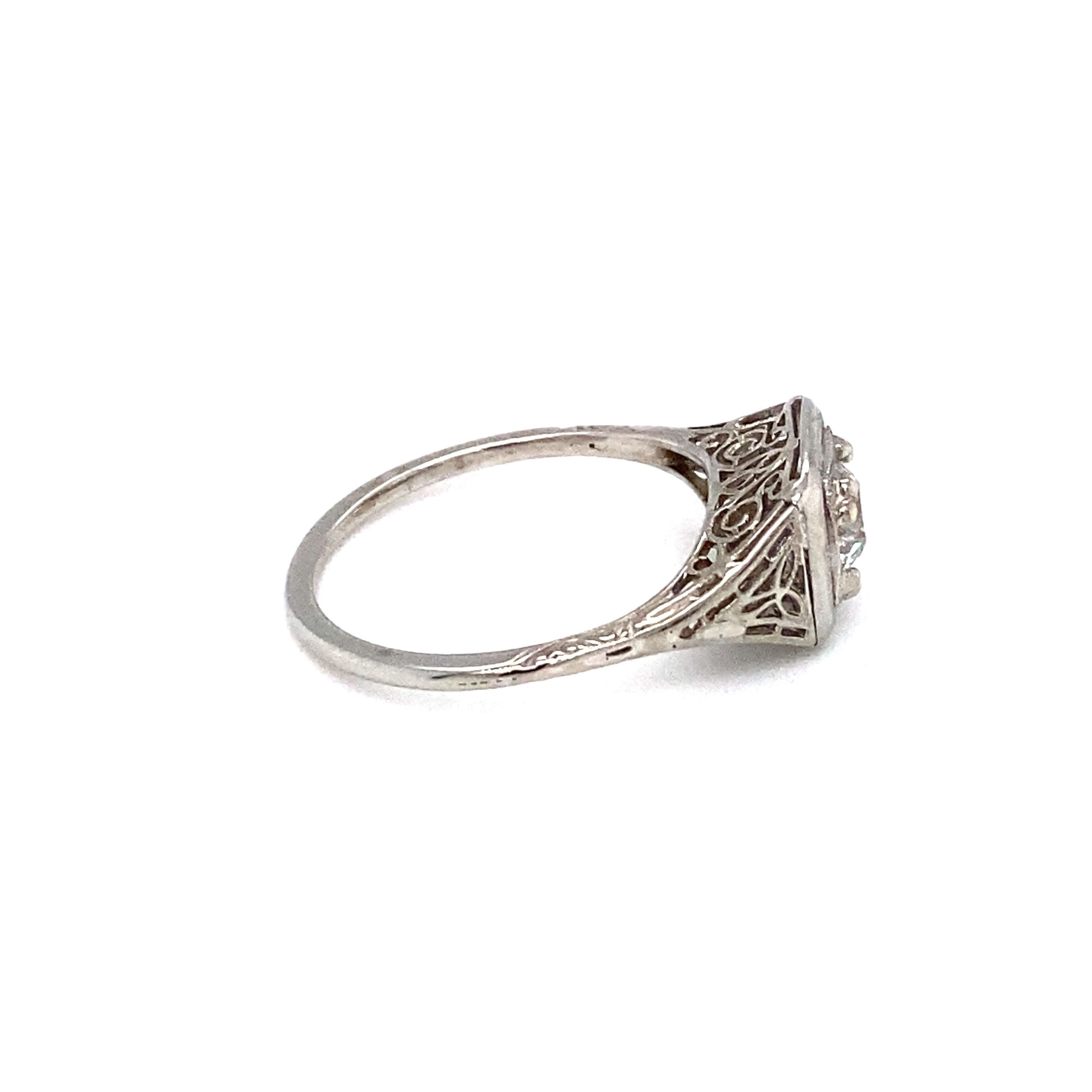 Item Details: This antique filigree ring has Art Deco style and a beautiful center Old Mine Cut diamond.

Circa: 1920s
Metal Type: 18 karat white gold
Weight:  2.2 grams
Size: US 7 and resizable

Diamond Details:

Carat: 0.35 carats
Shape: Old Mine