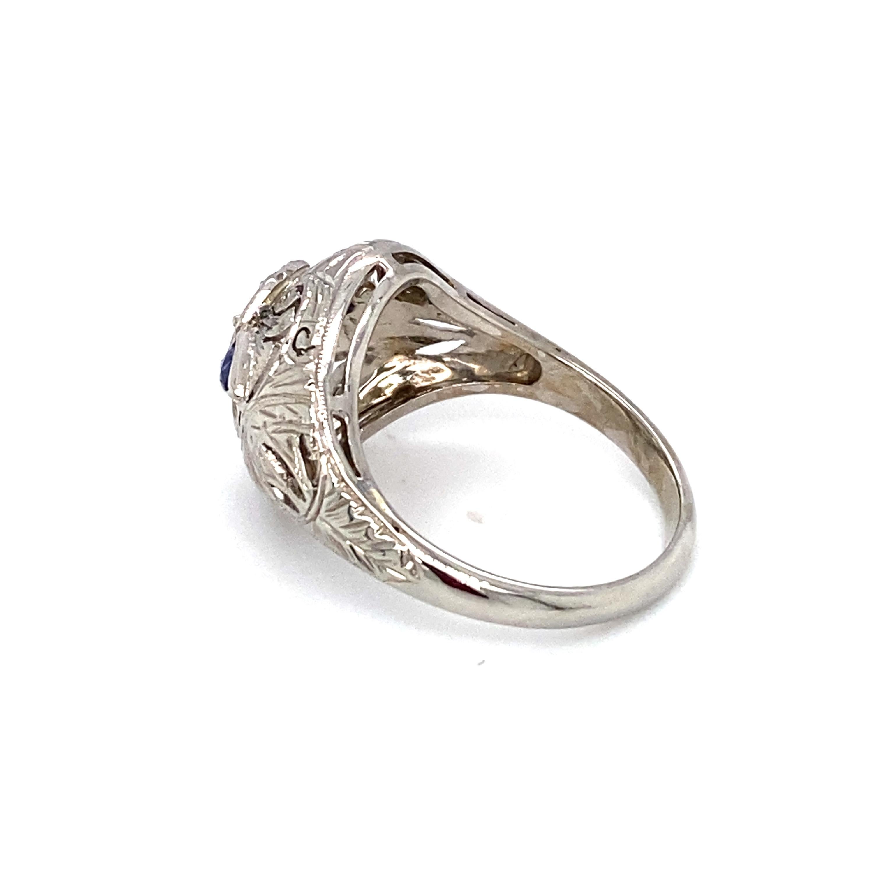 Item Details: 
A unique piece dating from the 1920s, this ring features a center diamond and sapphire accents, a true art deco masterpiece! 

Circa: 1920s
Metal Type: Platinum
Weight: 4.2 grams
Size: US 6, resizable

Diamond Details:
Carat: 0.65