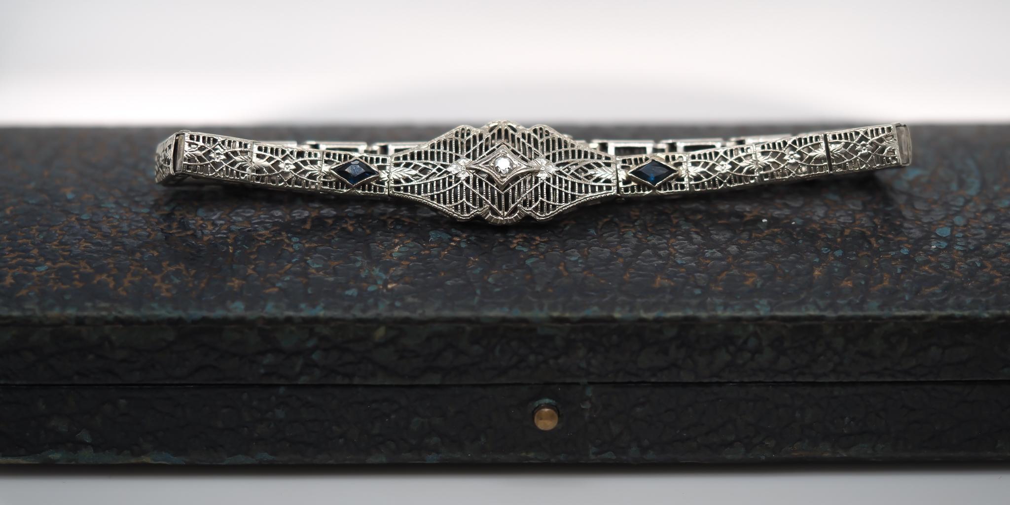 Year: 1920s
Item Details:
Metal Type: 10K Yellow Gold [Hallmarked, and Tested]
Weight: 6.2 grams
Stone Details: Diamond, Natural, Old Mine Brilliant, .05ct, H Color, VS Clarity
Saphire: Blue, Synthetic, Diamond Shape.
Bracelet Length Measurement: 7