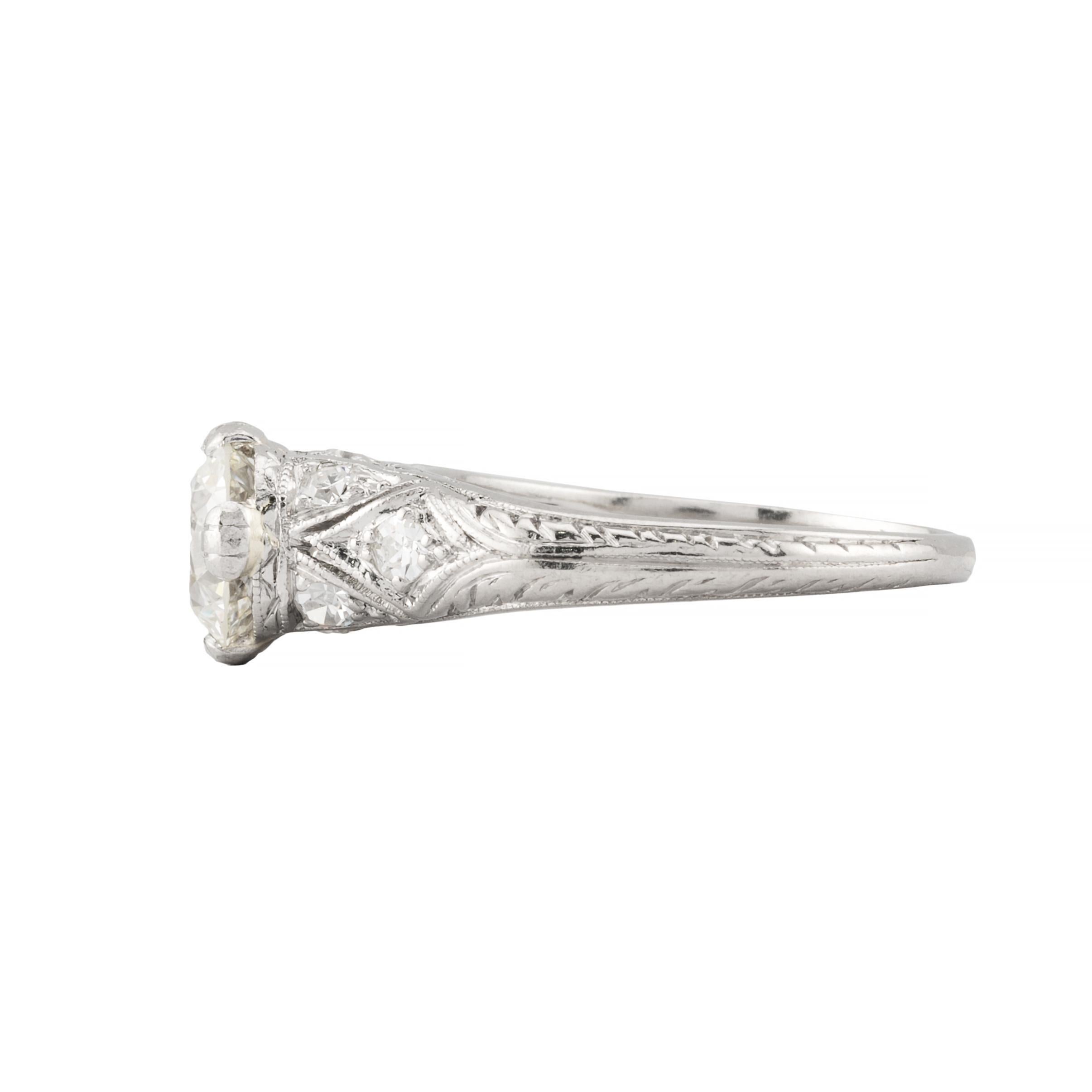 Aston Estate Jewelry Presents:

An Art Deco period diamond engagement ring in platinum.  Centered by a 1.12 carat antique European cut diamond of H color with VS1 clarity.  Accented by eight pave set European diamonds of 0.32 carats.  Complemented
