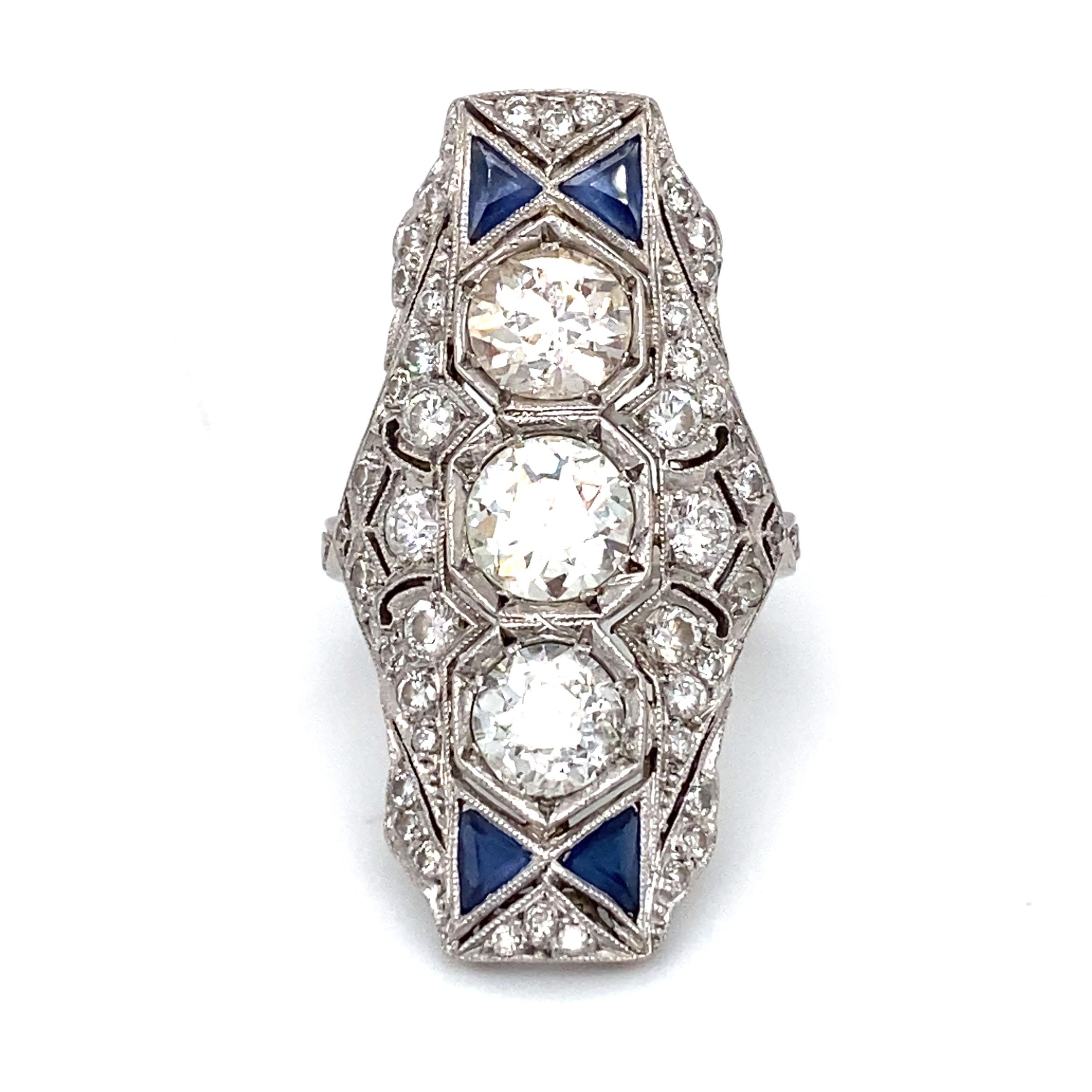 Item Details: 
This is an incredible Art Deco ring that features three large Old European cut diamonds accented by many smaller diamonds and sapphires. It is an excellent example of the captivating Art Deco jewelry era. One can only imagine who